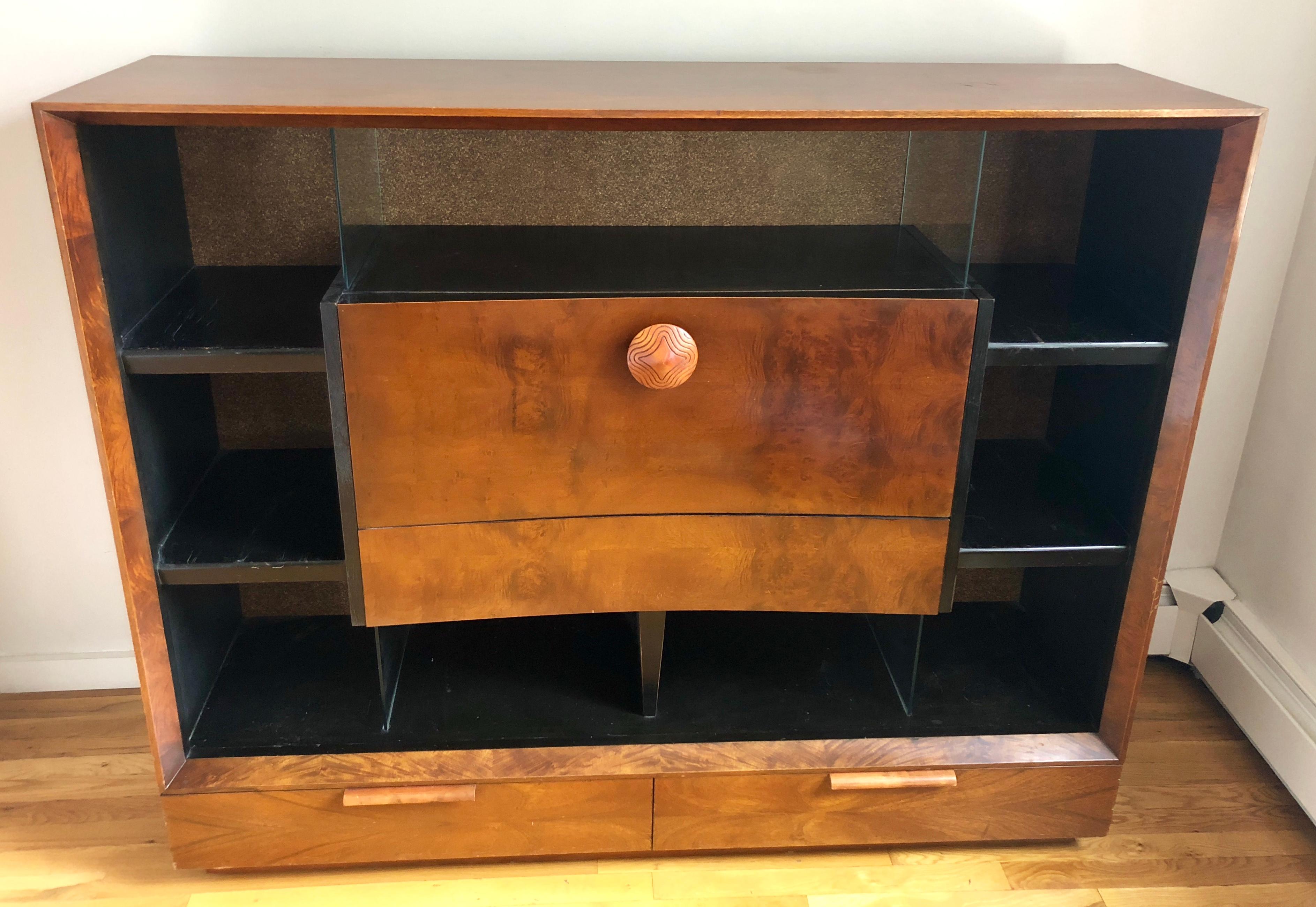 Bookcase with drop-front secretary desk and storage drawers in paldao wood. Glass dividers separate storage compartments, and cork-lined back. Retains Herman Miller tag. Great original condition.