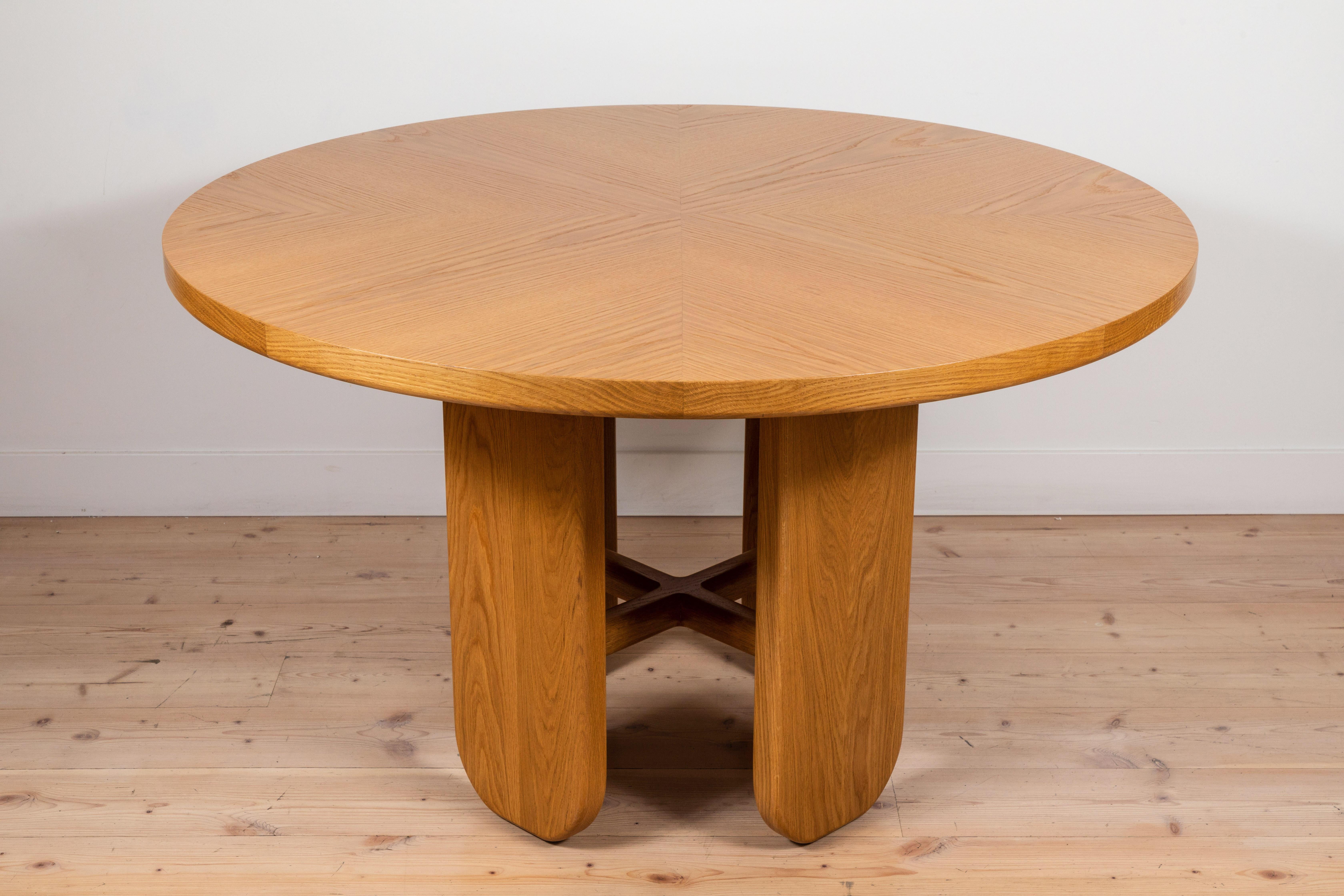 The Rainier Dining Table is part of the collaborative collection with interior designer Brian Paquette. The Rainier Dining Table features a parquet wood top and four pedestal legs connected with a solid wood stretcher. This piece is available in