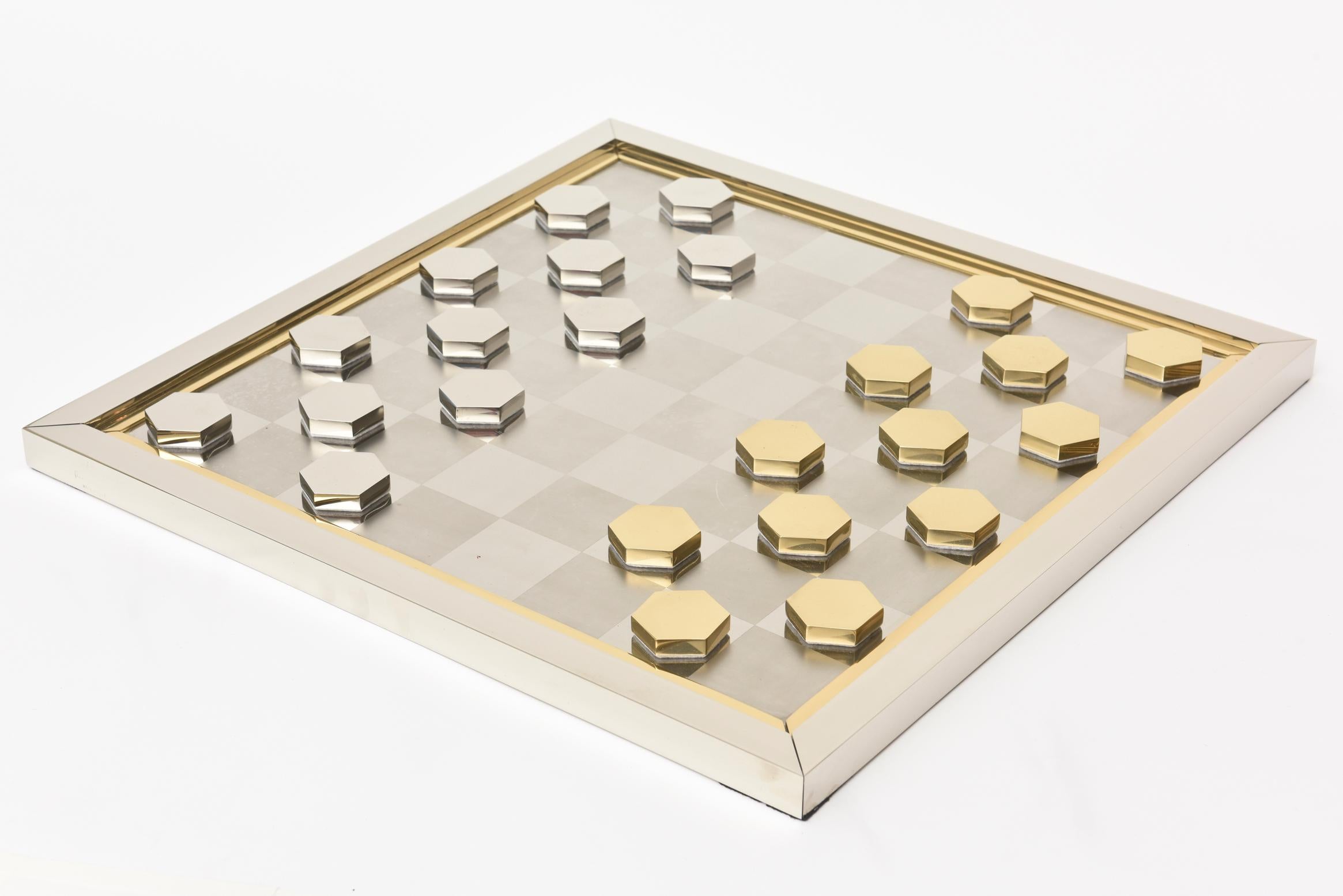This ultra chic and modern signed Italian Romeo Rega vintage checkers game has sculptural components. It is great just even as a decorative object or for real playing the game of checkers. It is from the 1970s. The board is square with a brass inner