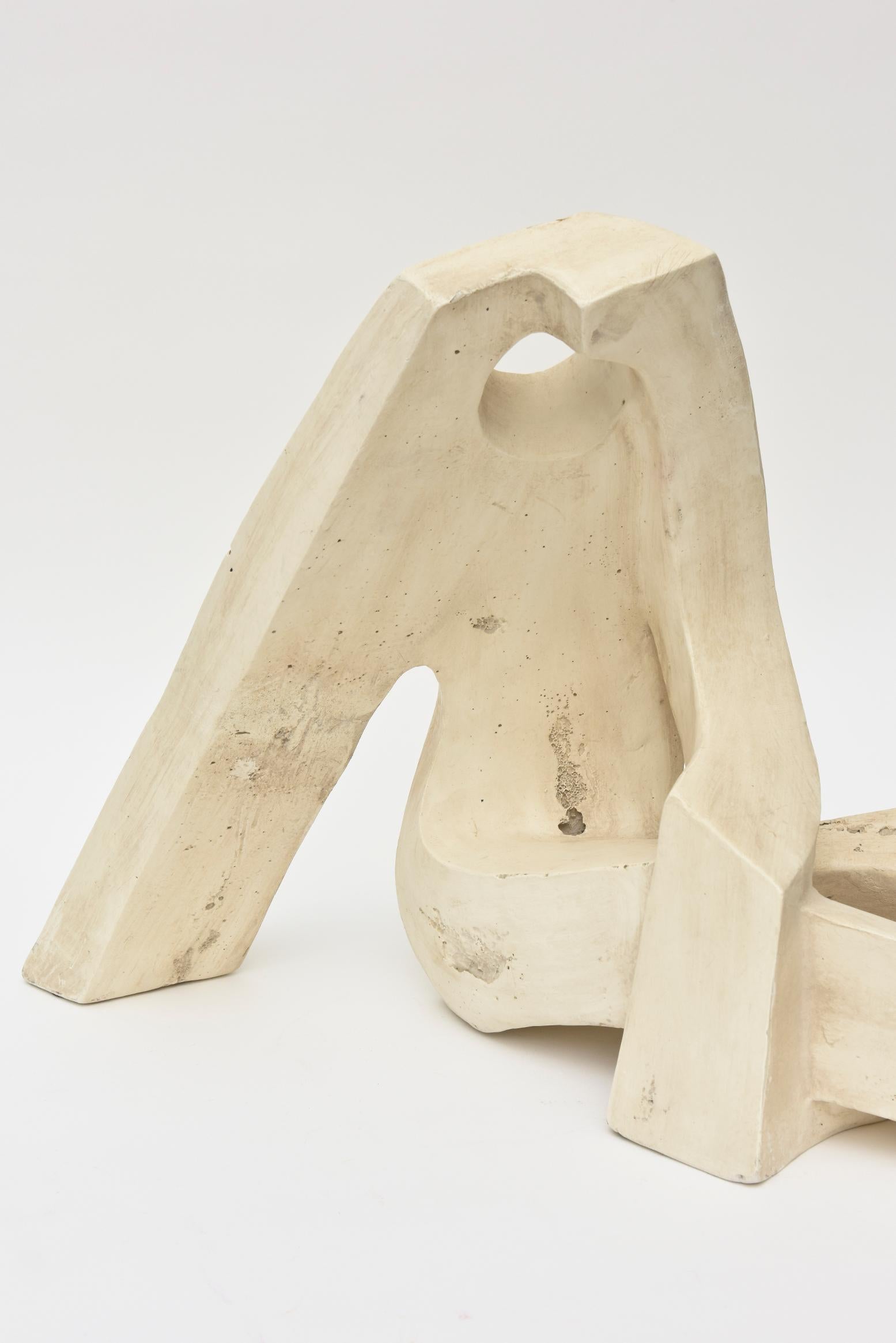 This fabulous seated vintage modernist stone sculpture is abstract. The views change with the different angles. It is of a stone composition but does not have the heavy weight of solid stone. It is not signed but is a real special modernist