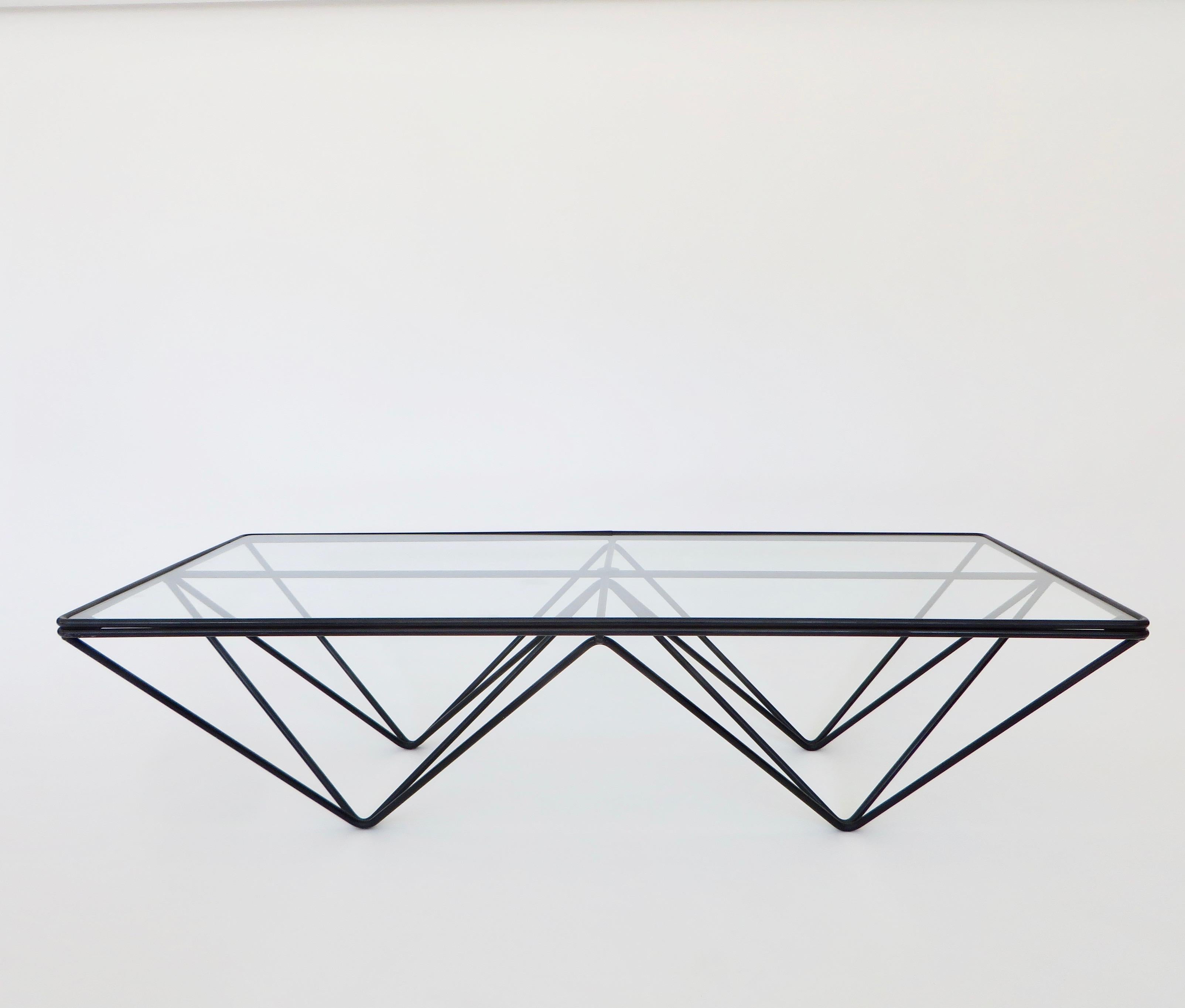 A coffee table in the style of the Alanda low coffee table by Paolo Piva of welded black enamel steel rods with a new glass top. 
Welded enameled steel rods with a glass top.
This could be used as a small coffee table or a side table. New glass.