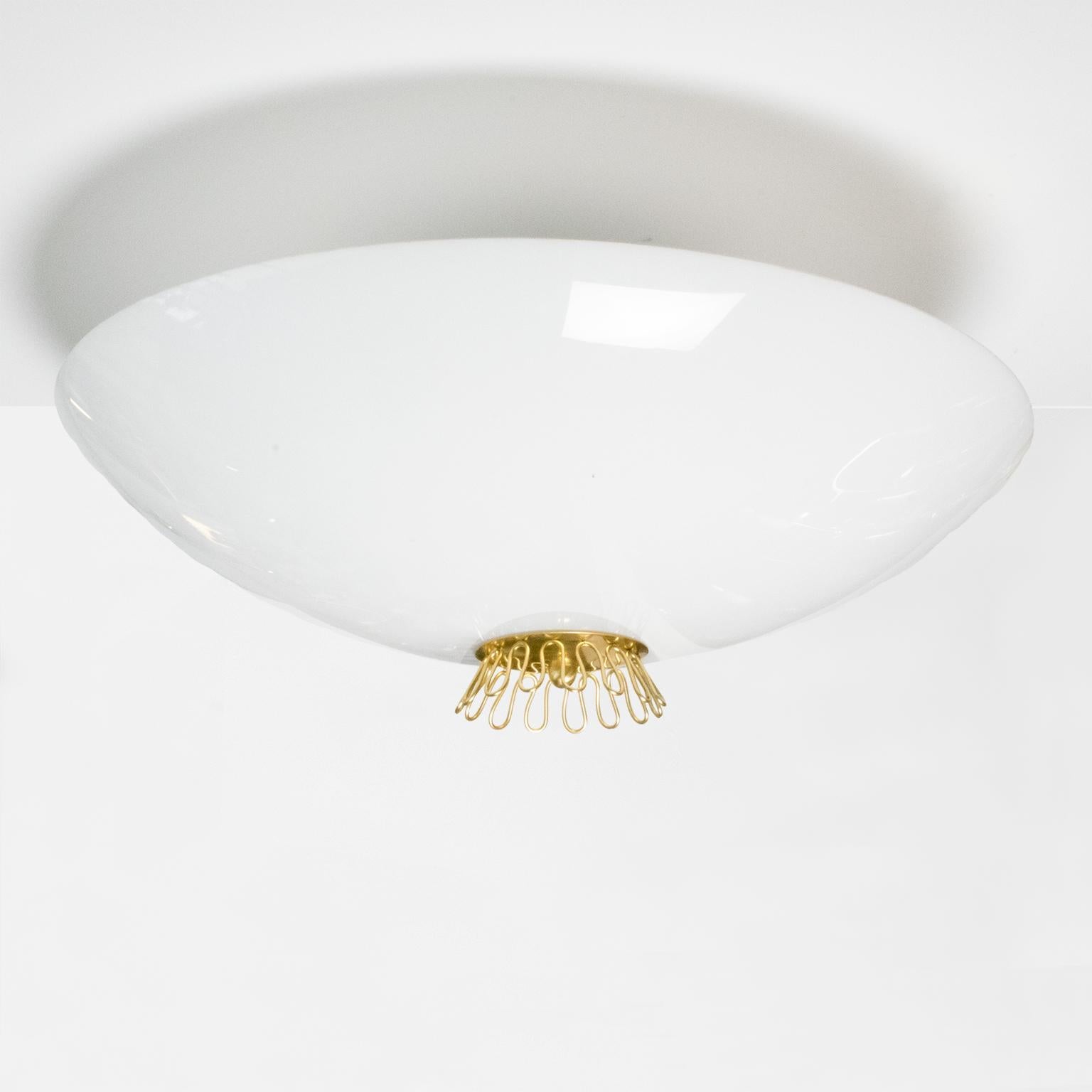 A large Scandinavian Modern Idman OY opal glass and brass flush-mount. The saucer shaped glass shade is detail with a decorate brass wire design mounted on a brass finial. Newly rewired with three standard base sockets for use in the USA. Mounting