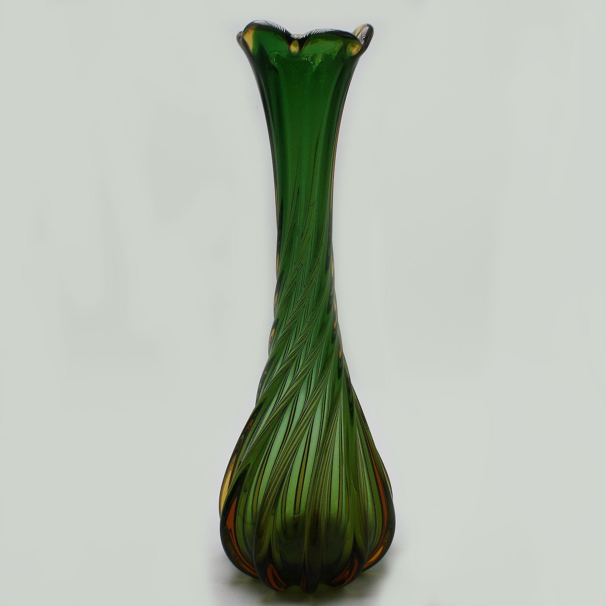 Green twisted Murano glass vase, circa 1960
Measures: 6” diameter x 16 1/2” height.