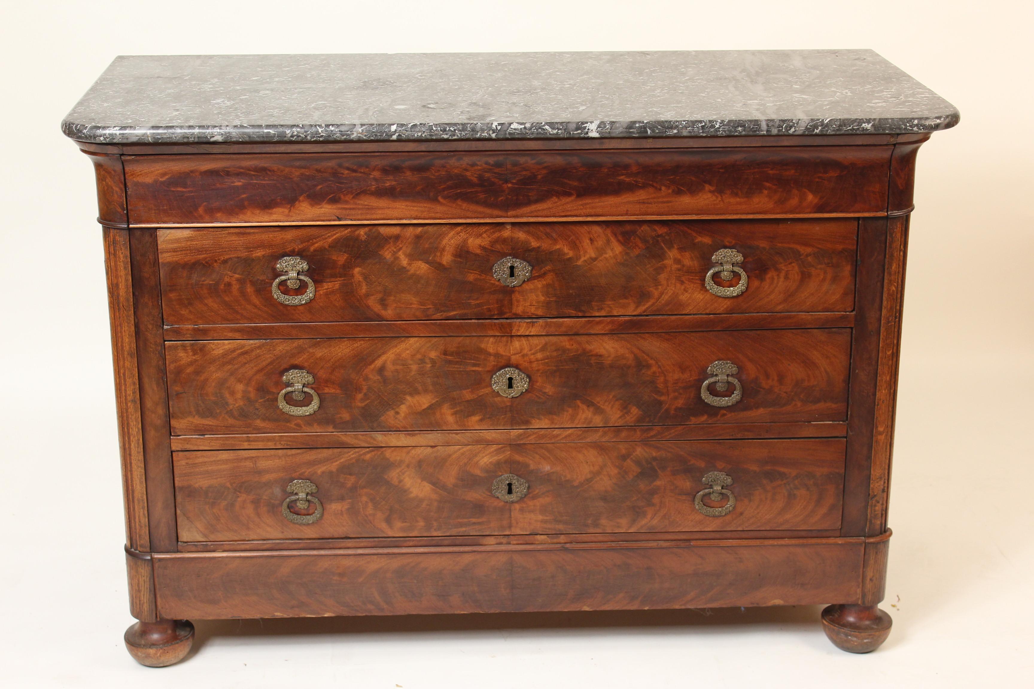 Charles X flame mahogany and oak chest of drawers with bronze drawer pulls, bronze escutcheons and a marble top, circa 1835. This chest has very nicely figured mahogany used on the front, the sides are oak.