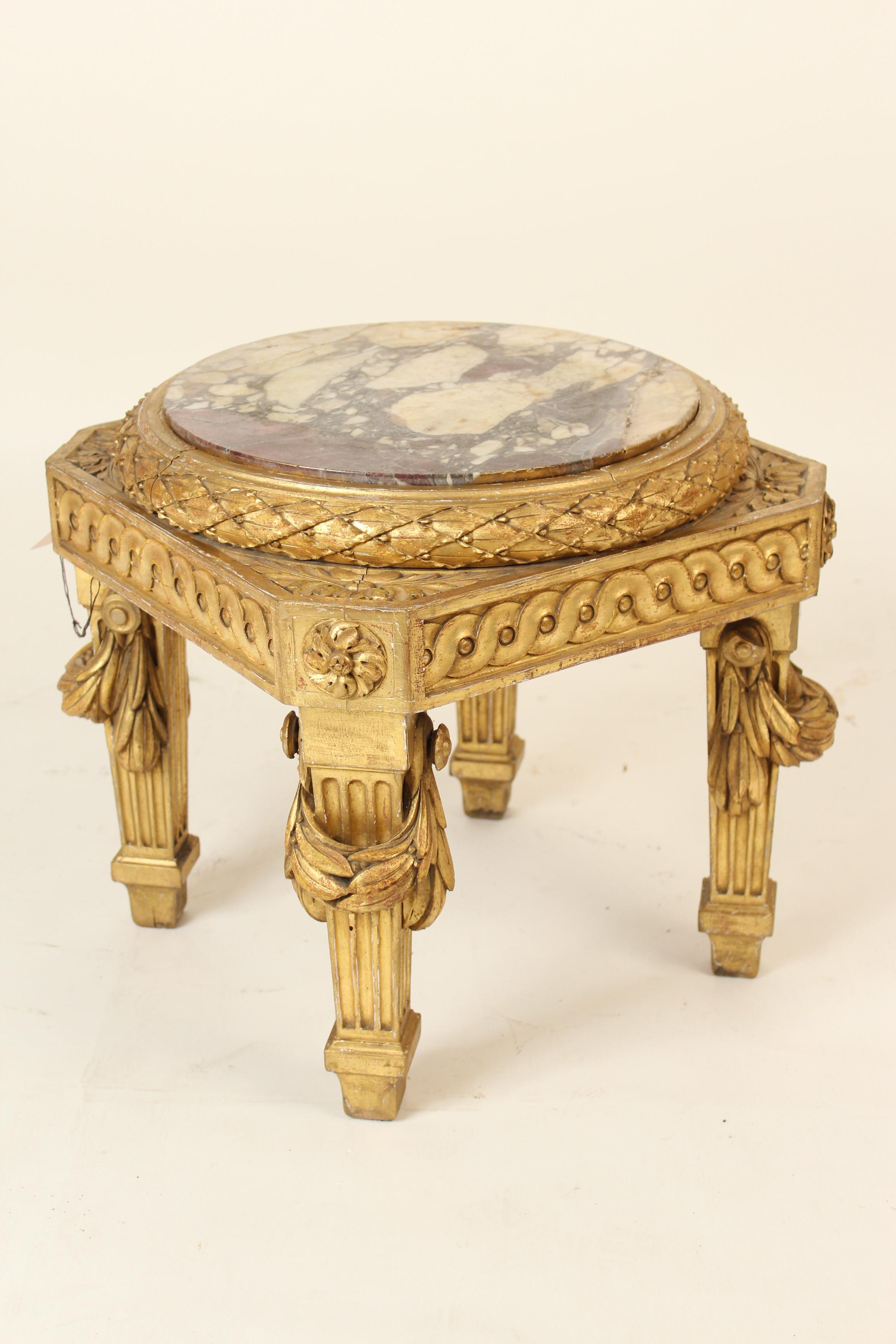 Louis XVI style gilt wood low occasional table, 19th century. With old original marble top, surrounded by a band of carved gilt wood laurel design carving, apron with carved gilt wood guilloche, resting on square tapered fluted legs with swag