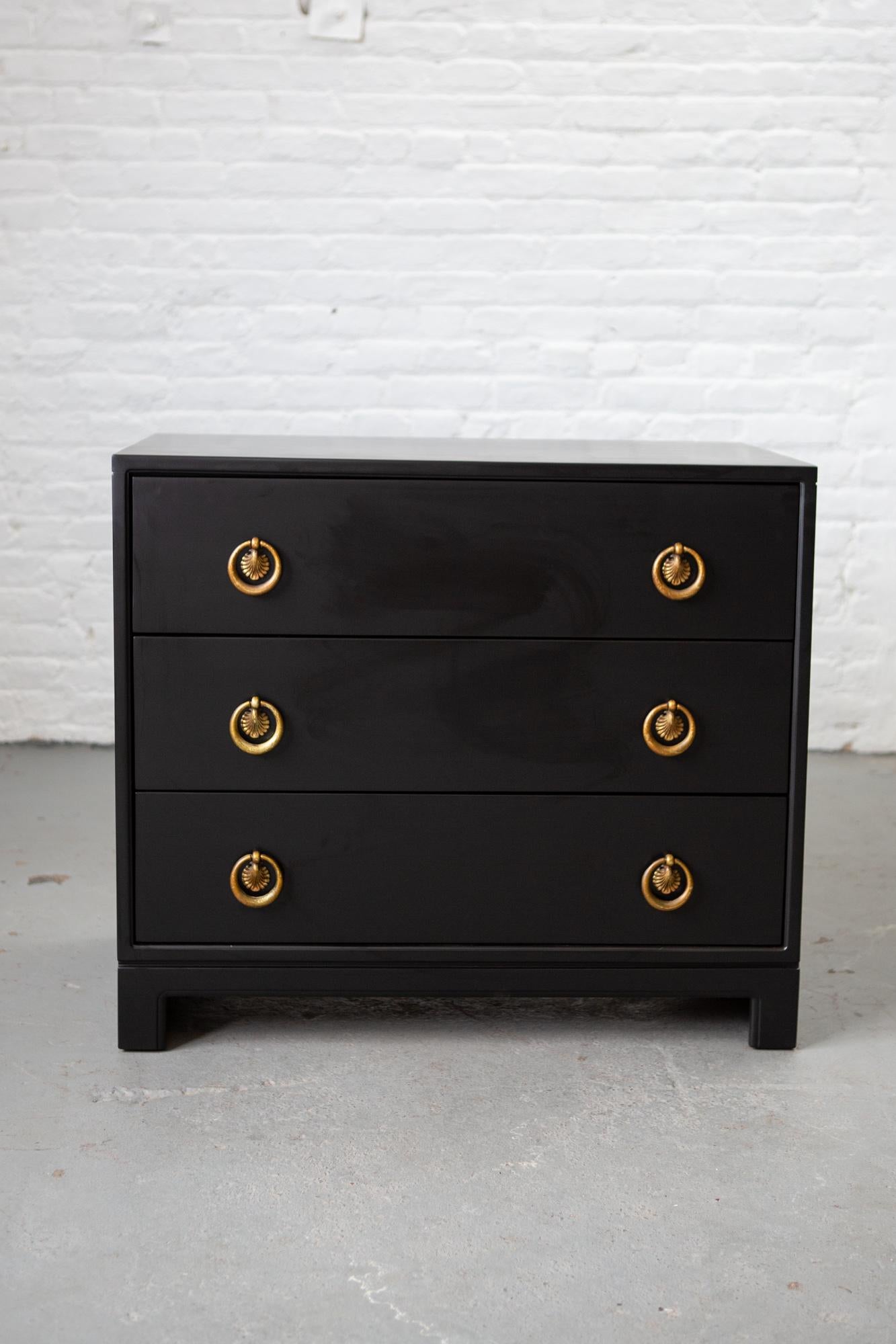Black lacquered three-drawer midcentury chest of drawers with beautifully patinated gold ring pulls. Very handsome and sturdy piece!