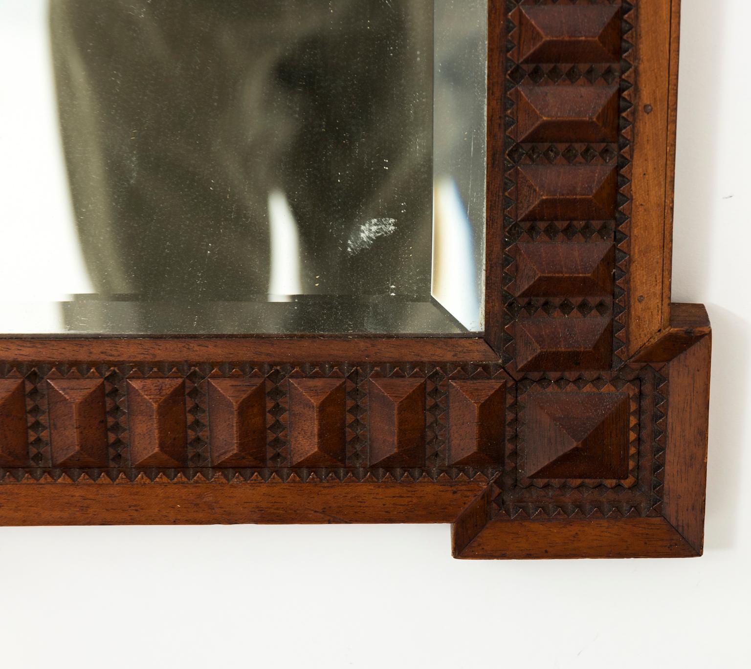 Carved wood mirror with dog ear corners and nail-head trim, circa mid-20th century.
   