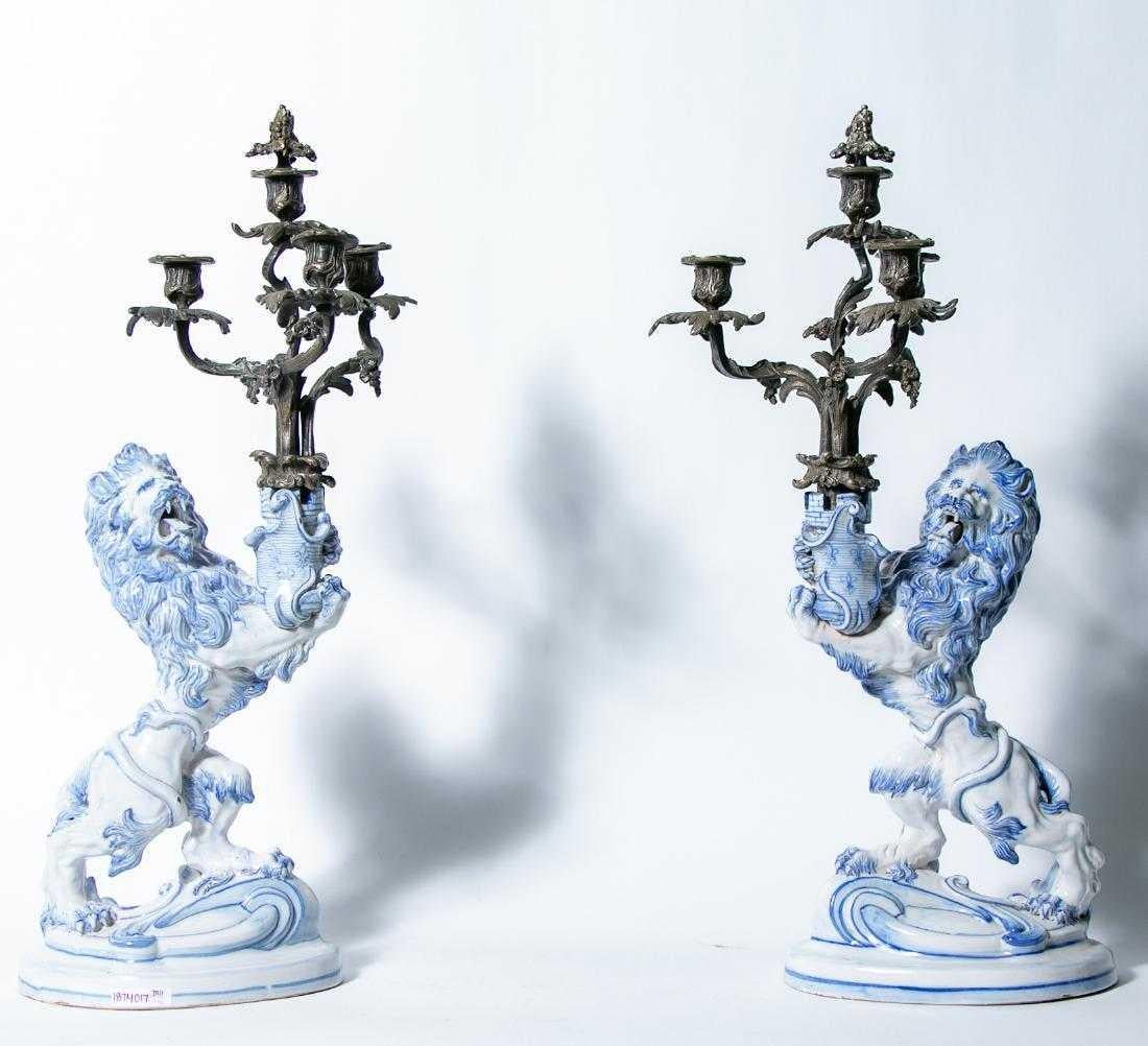 Pair of signed Emile Galle (French, 1846-1904) rampant lion faience candleholders 

Heraldic lion holding a castle tower in rampart also holding silvered bronze candelabra 
Signed, 