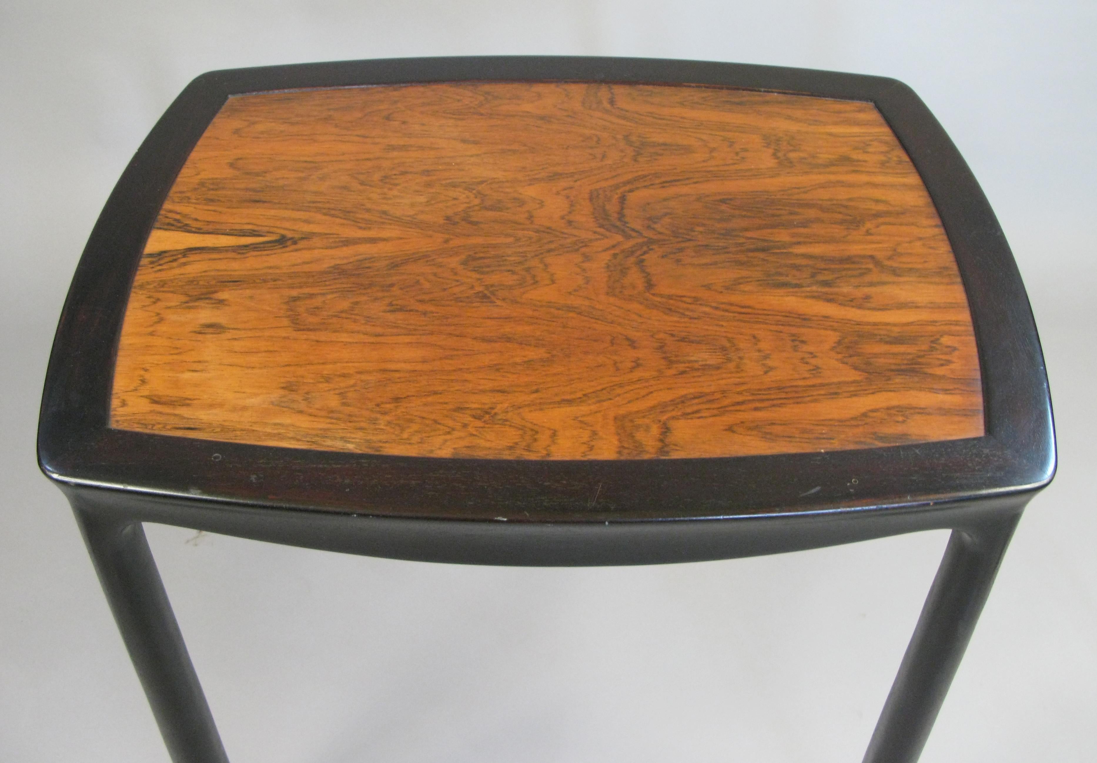 A very nice vintage 1960s occasional table by Edward Wormley for Dunbar. Beautiful details with subtly curved top and skirt, and legs which are slightly wider at the base. Frame is ebonized mahogany and the inset top is rosewood.