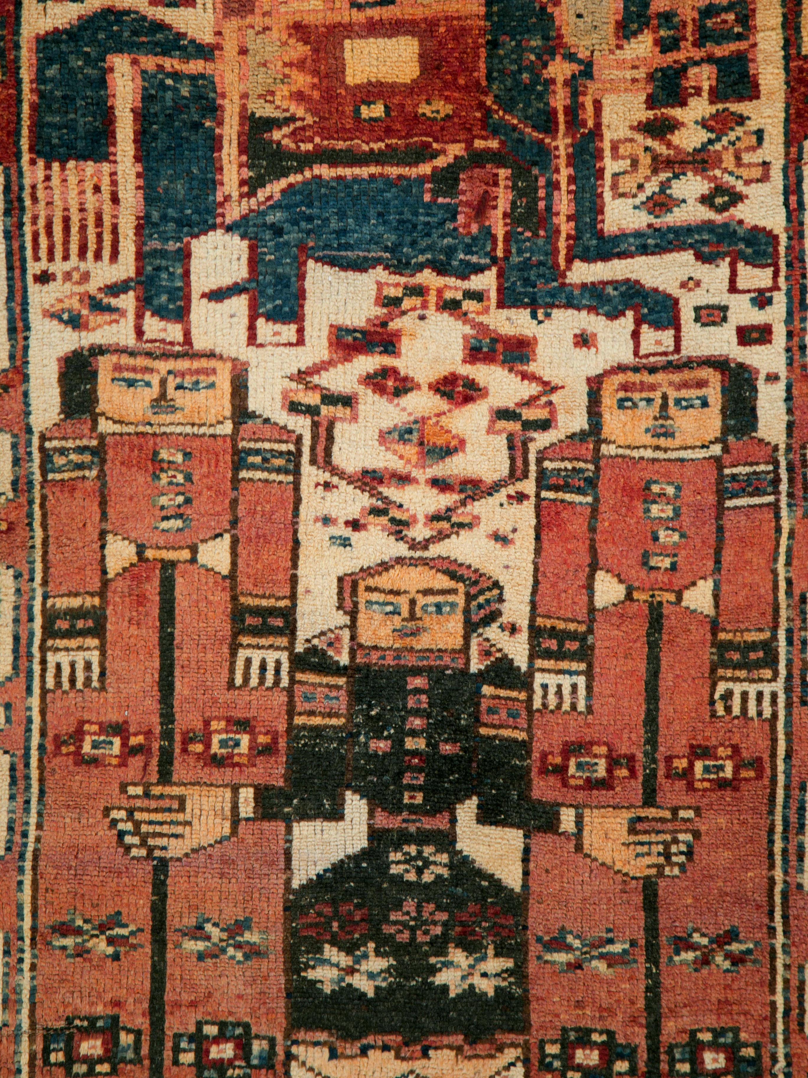 A vintage Persian Bakhtiari rug from the mid-20th century woven in the gallery format. The semi-geometric pictorial design and color palette offers a tribal and rustic appeal.