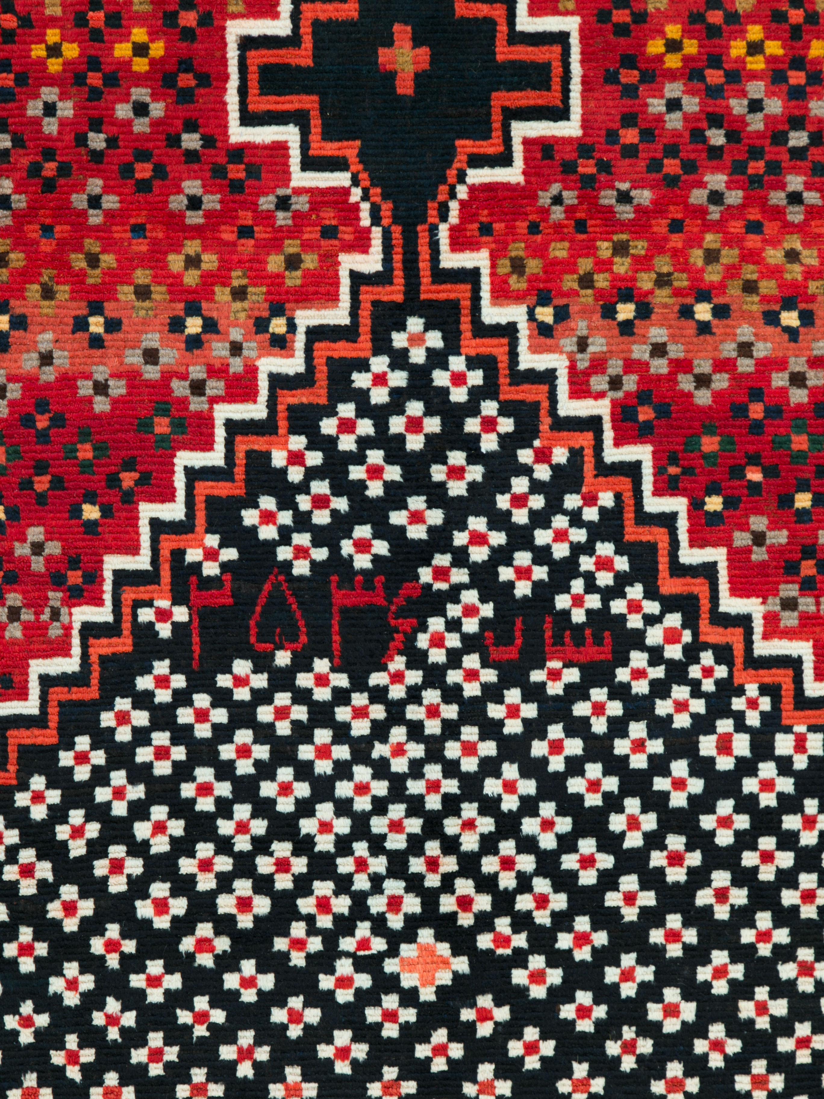 A vintage Persian Gabbeh rug woven by the nomadic Qashqai tribe. This is definitely a conversational piece and one created for an artsy individual that can enjoy the quirkiness of vintage tribal rugs. Aside from the offset medallion and highly