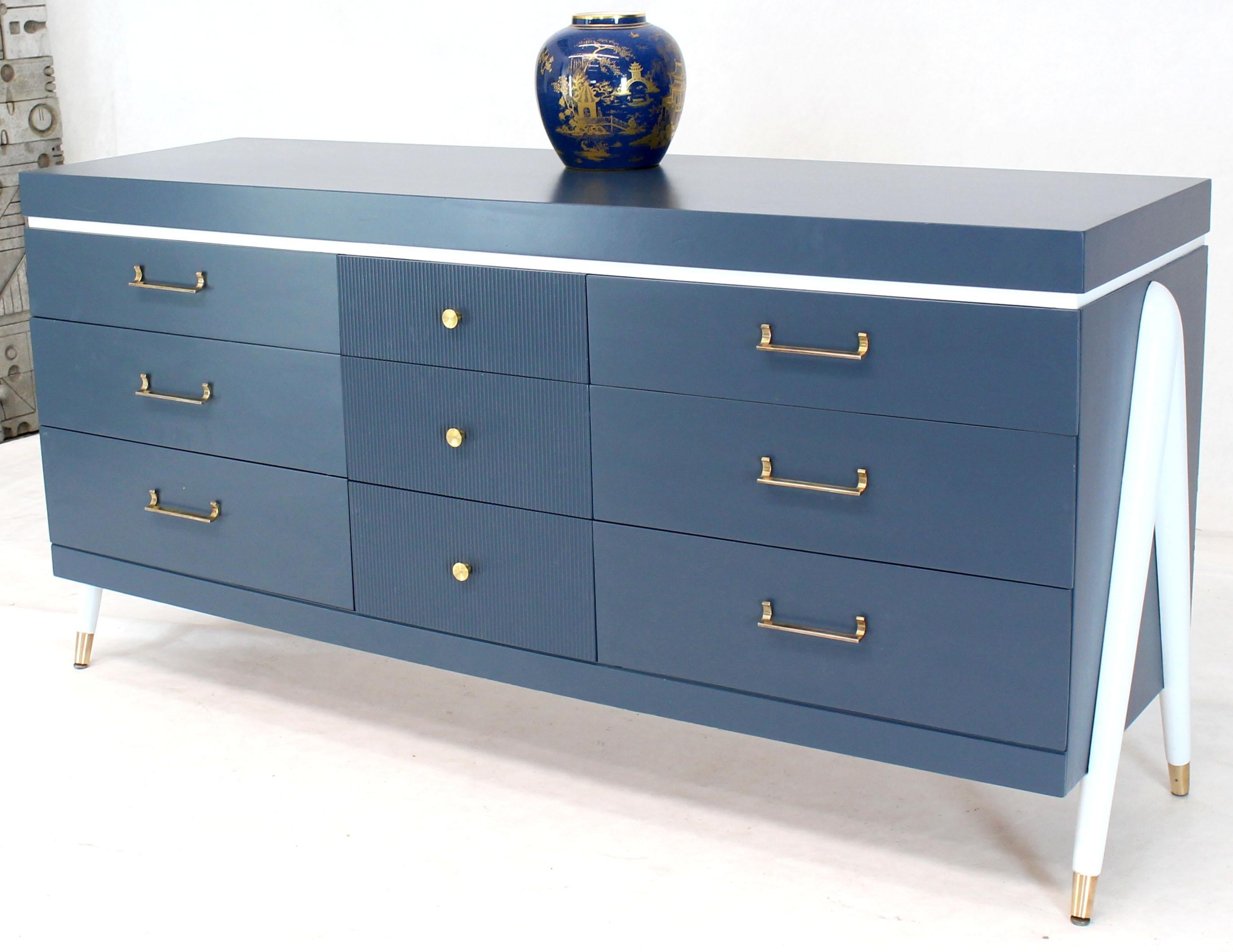 Mid-Century Modern long credenza nine drawers dresser with exposed sculptural compass shape legs. Brass hardware pulls.
 