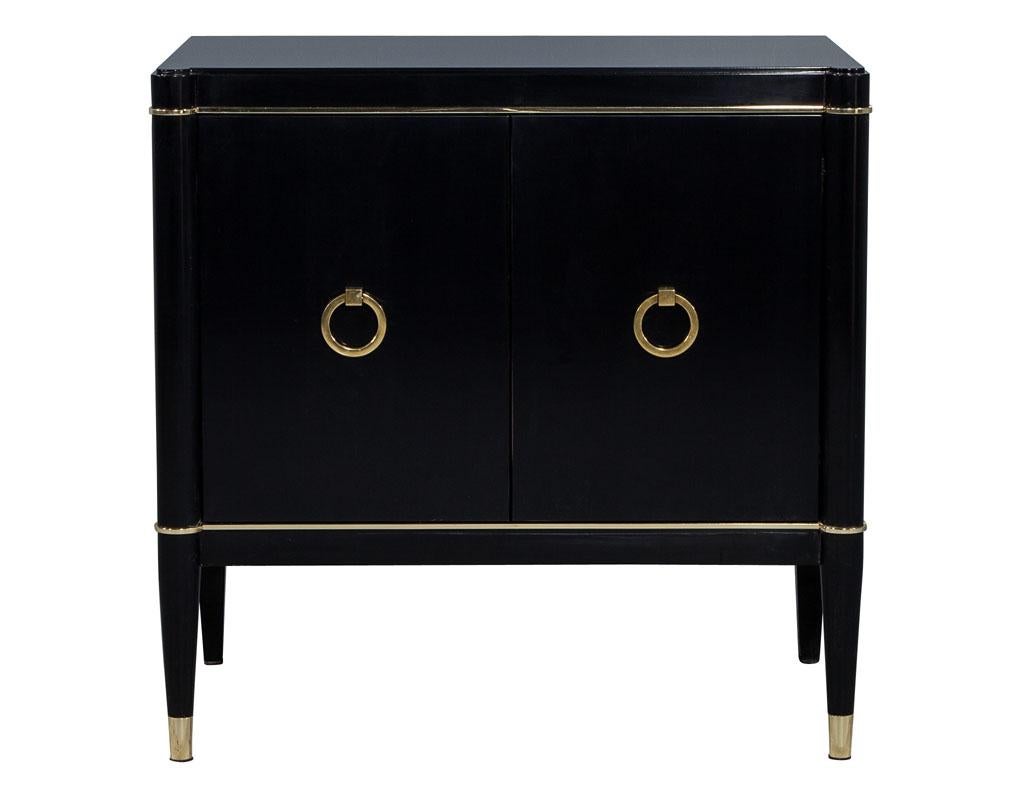 Carrocel custom Art Deco style two-door nightstand chest. Finely detailed brass inlay and foot caps adorn this beautifully sculpted Art Deco inspired piece, with flowing rounded corners and delicate brass hardware, beautifully finished in a hand