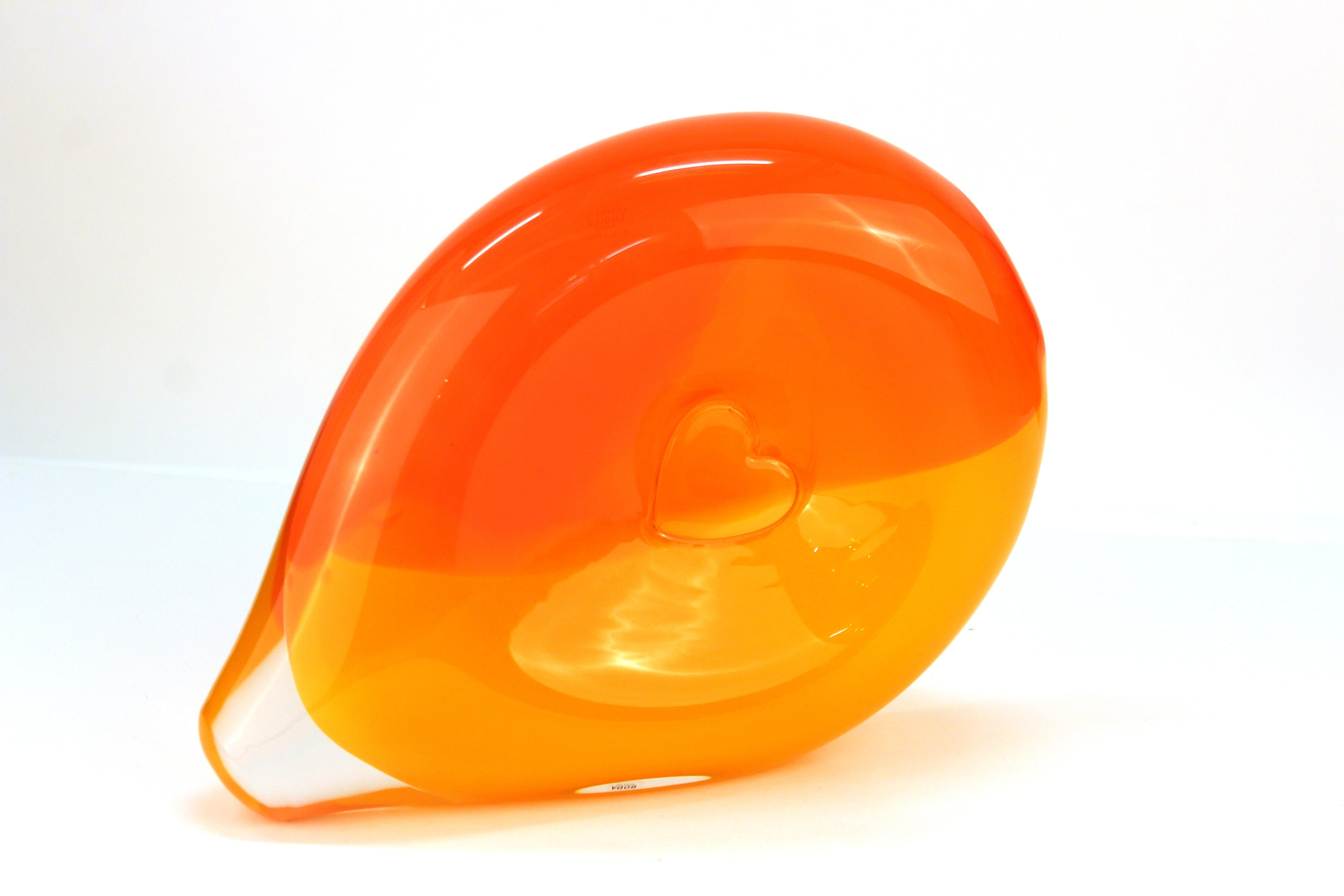 Mid-Century Modern 'Bali' sideways glass vase with a central heart motif, created by Kjell Engman for Swedish glass-maker Kosta Boda. The vase has shades of tangerine and red-orange cased in clear glass and comes with two Kosta Boda tags on the side