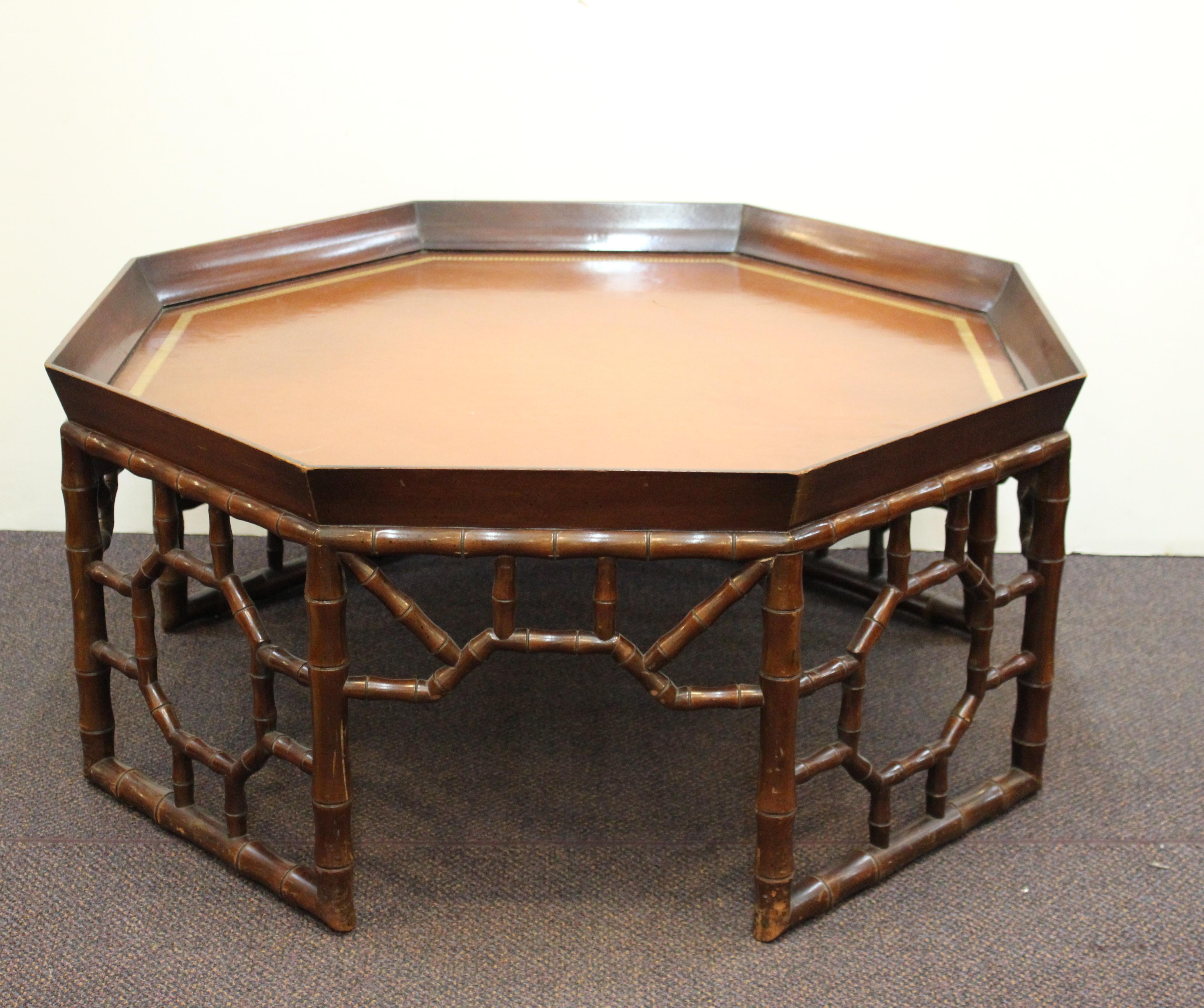 Hollywood Regency hexagonal coffee or cocktail table in faux bamboo, made by the Baker Furniture Company in the 20th century. The piece has age-appropriate wear and is in great vintage condition.