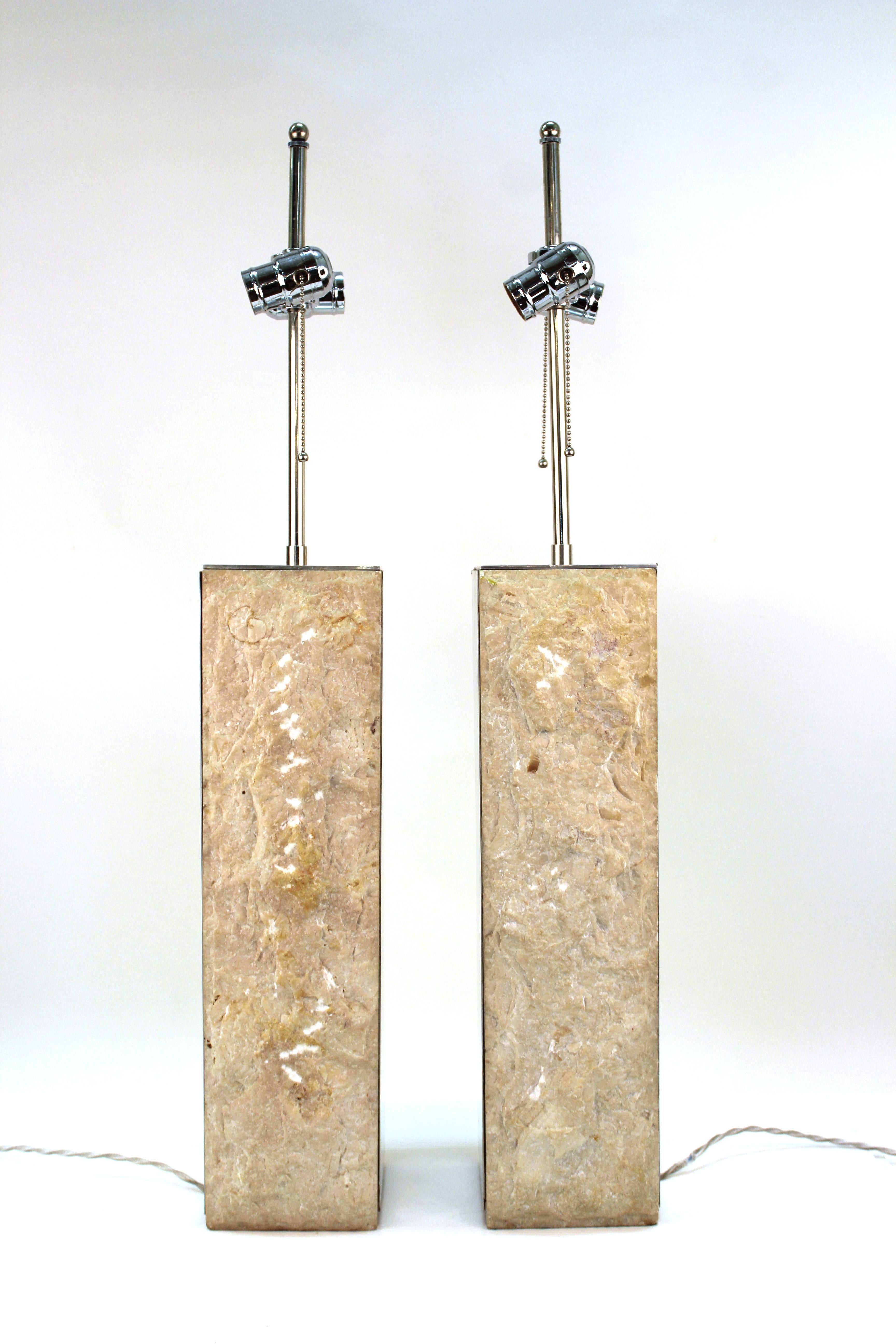 Modern Brutalist style pair of table lamps with metal structure and stone elements on the sides. Made in the United States during the 1970s-1980s. One lamp has a dent to the metal on one upper corner and a chip to the stone panel. In good vintage