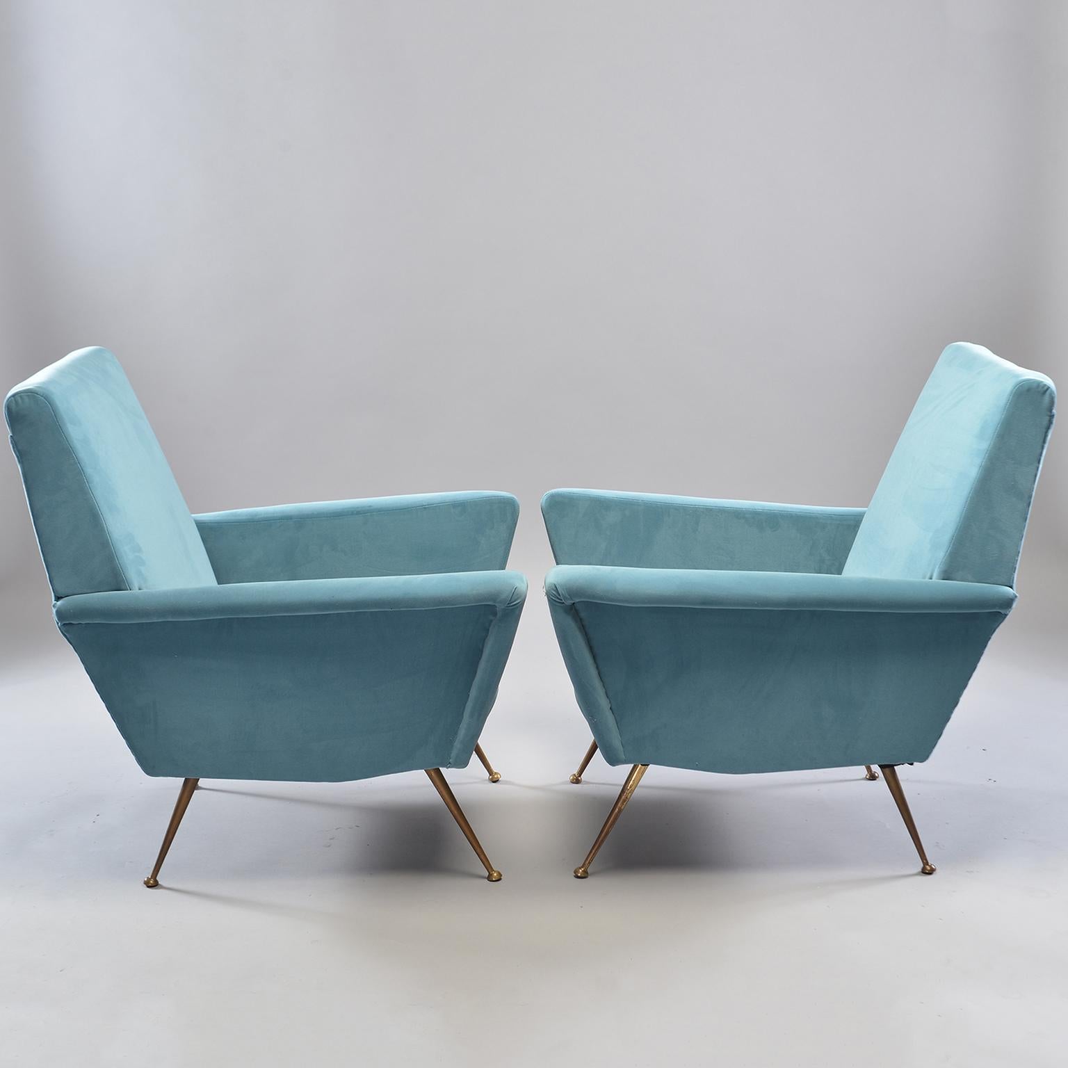 Pair of Italian midcentury armchairs with great lines, flared boxy arms and slender gold tone metal legs. Newly upholstered in Europe in a sky blue mole skin fabric. Measures: Seats are 15-3/4
