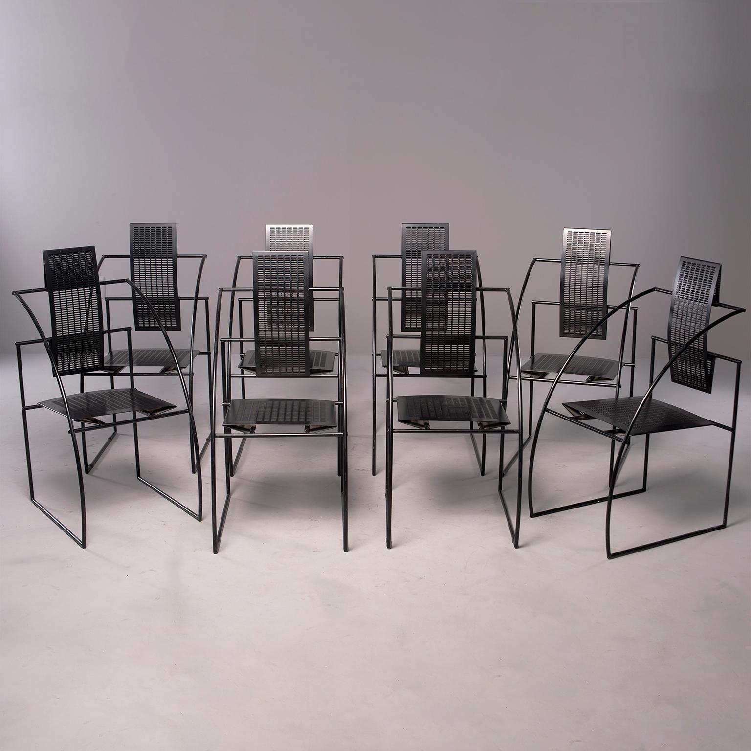 Offered are a set of eight quinta chairs designed by Mario Botta for Alias of Italy. These black metal chairs have a distinctive op art look with curvy arms and mesh metal seats and backs. Can be used indoors or out. Measures: Seats are 16.75