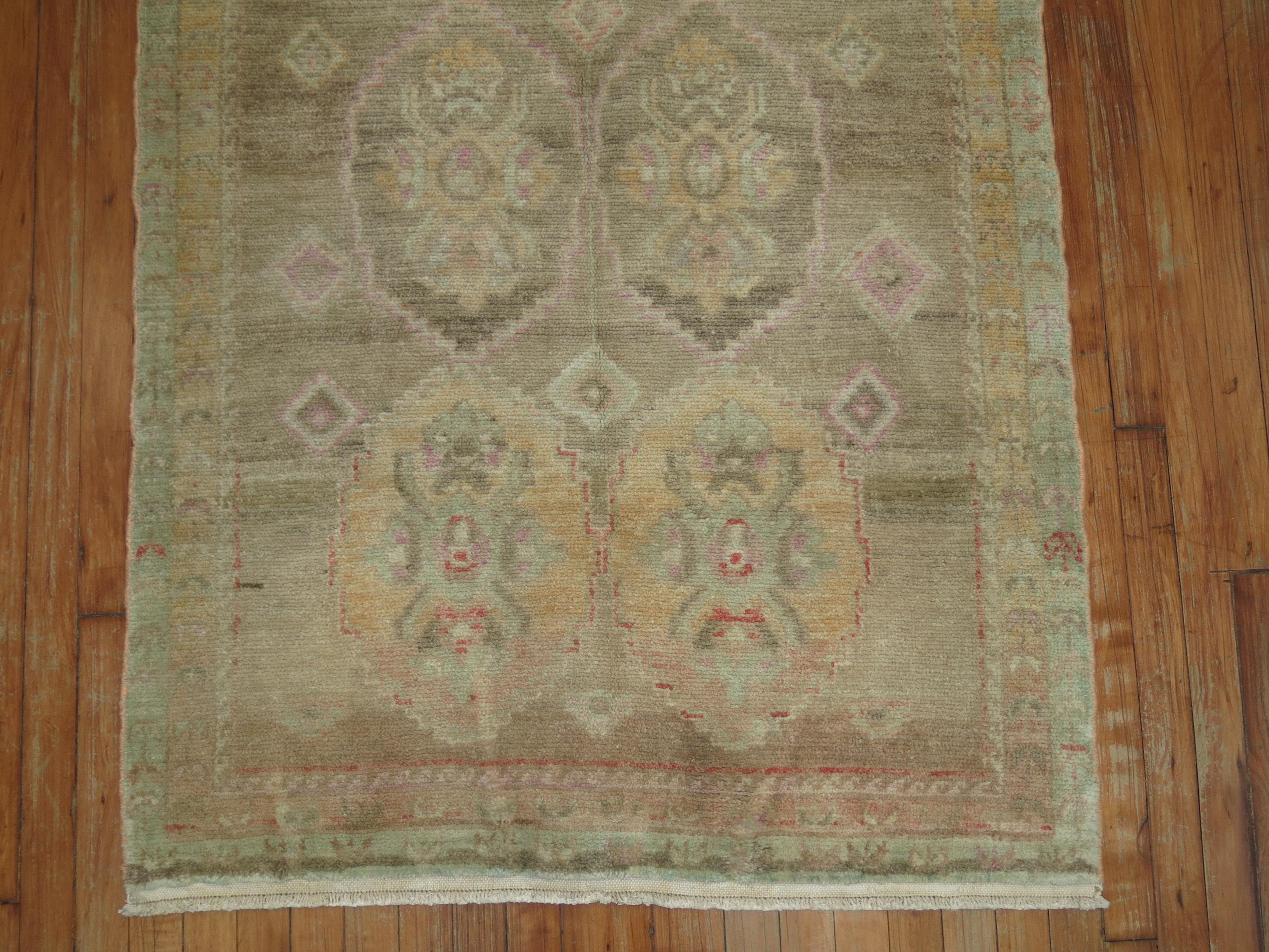 Turkish runner with a beige field, accents in browns and pink.

Measures: 3'6