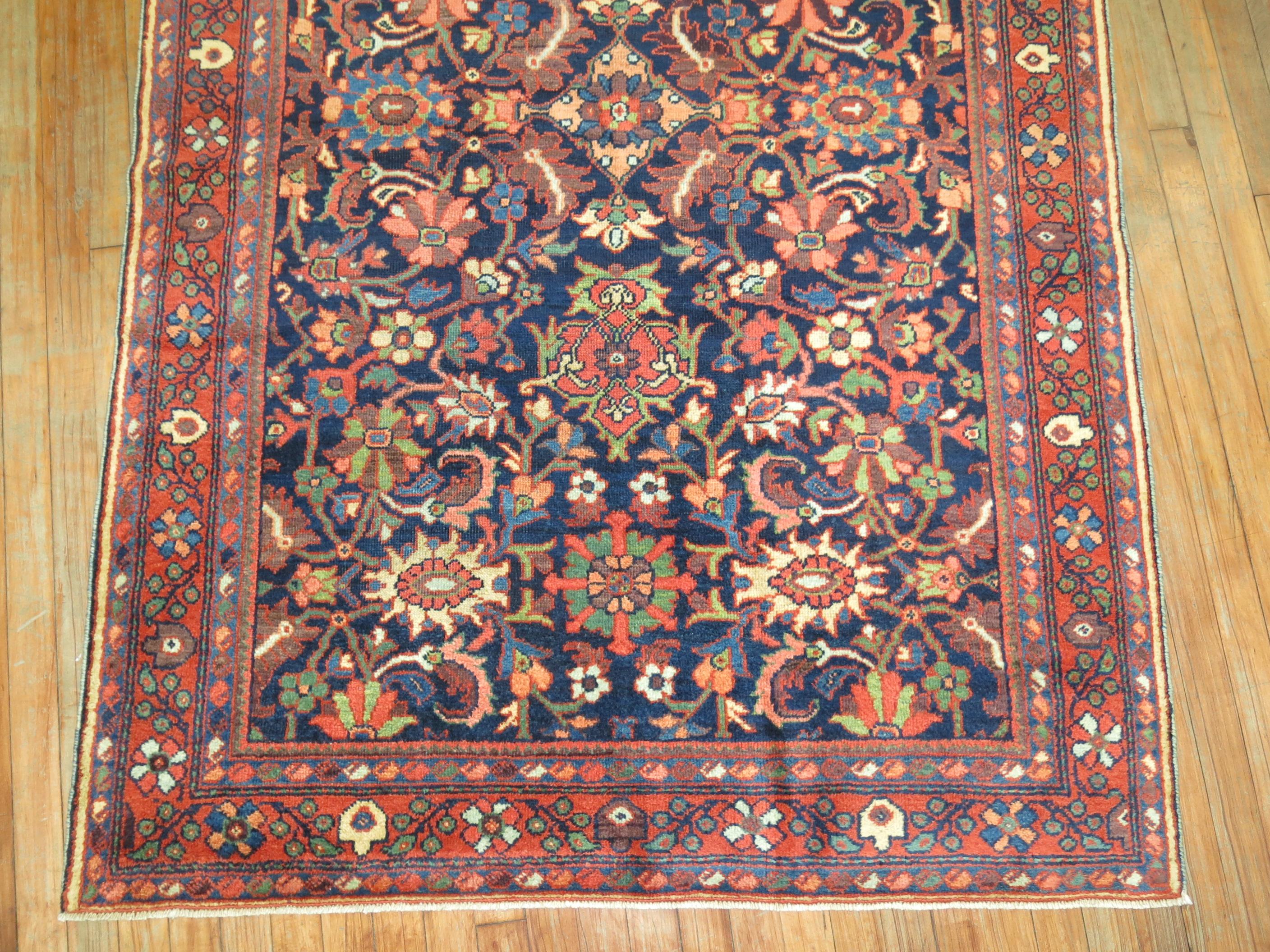 Scatter or intermediate size Persian Mahal rug with a blue field and orangey-red border.

Mahal Persian carpets from the 19th century and turn of the 20th century have become one of the most desirable among Persian village weavings, as they appeal