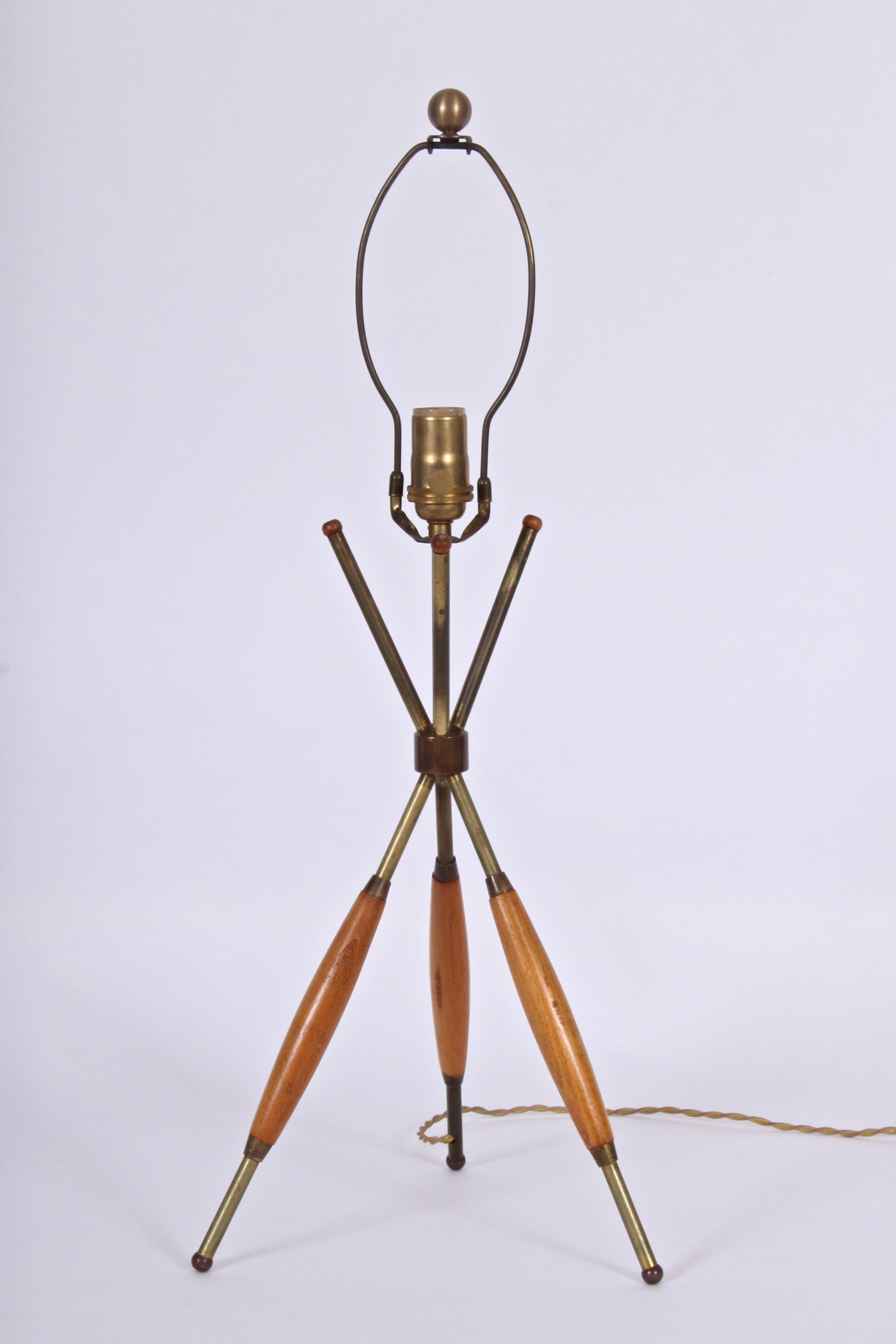 American Mid-Century Modern Gerald Thurston for Lightolier walnut and brass tripod reading table lamp. Featuring patinated brass tripod base with walnut trim. Shade shown for display only. Shade measurements: (10 H x 8 D top x 15 D bottom). 19 H to