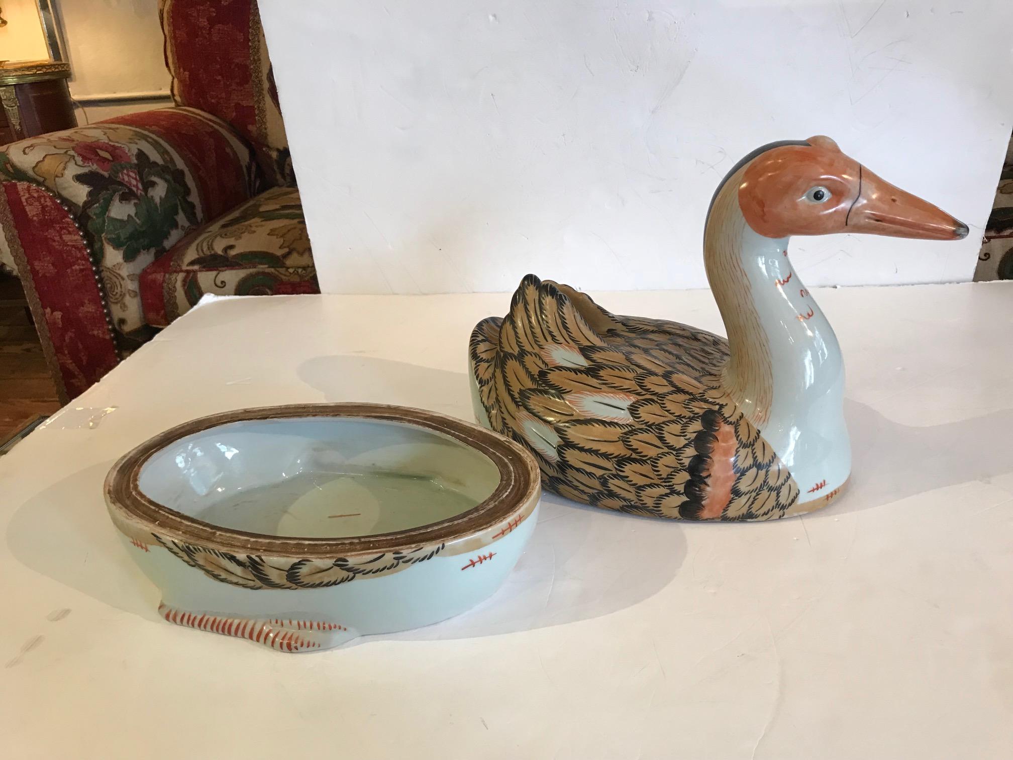 Wonderful Chinese tureen or shallow bowl with duck shaped top, hand-painted and charming from beak to tail feathers.
Stamp on bottom but undecipherable.
 
 