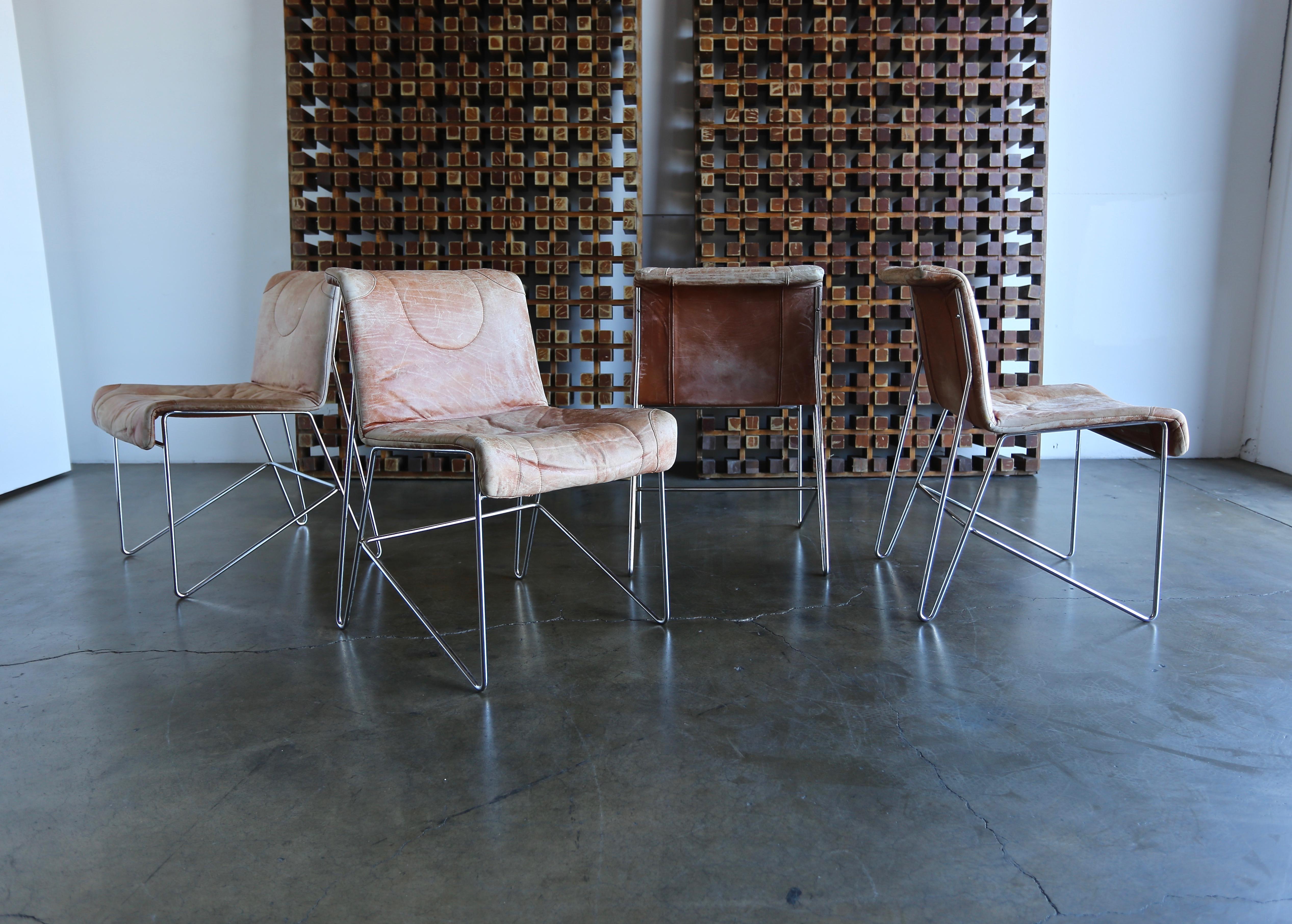 Four i4 Mariani leather and chrome Italian modern dining chairs. Beautifully distressed original leather to the seats.