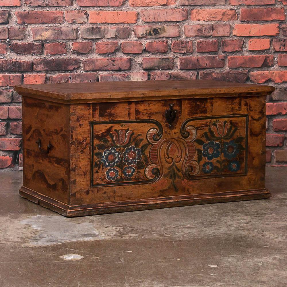 The charm of this original painted trunk comes from the floral painting that still graces the front, even after 150 years of use. When opened, you see a small 