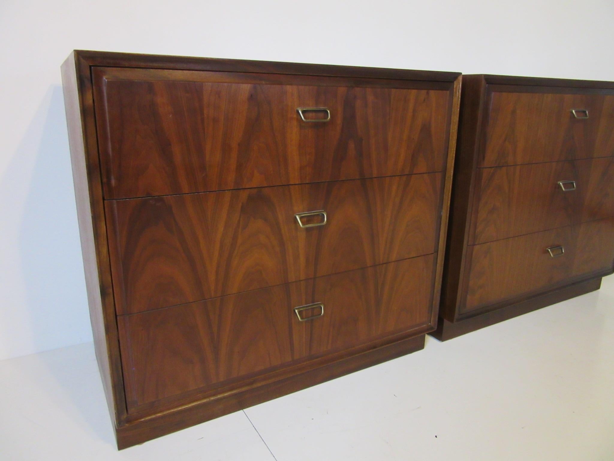 A pair of well grained small walnut three drawer chests with brass toned pulls, very well constructed manufactured by the Founders Furniture Company . With the scale of these chests they could be used as larger nightstands.