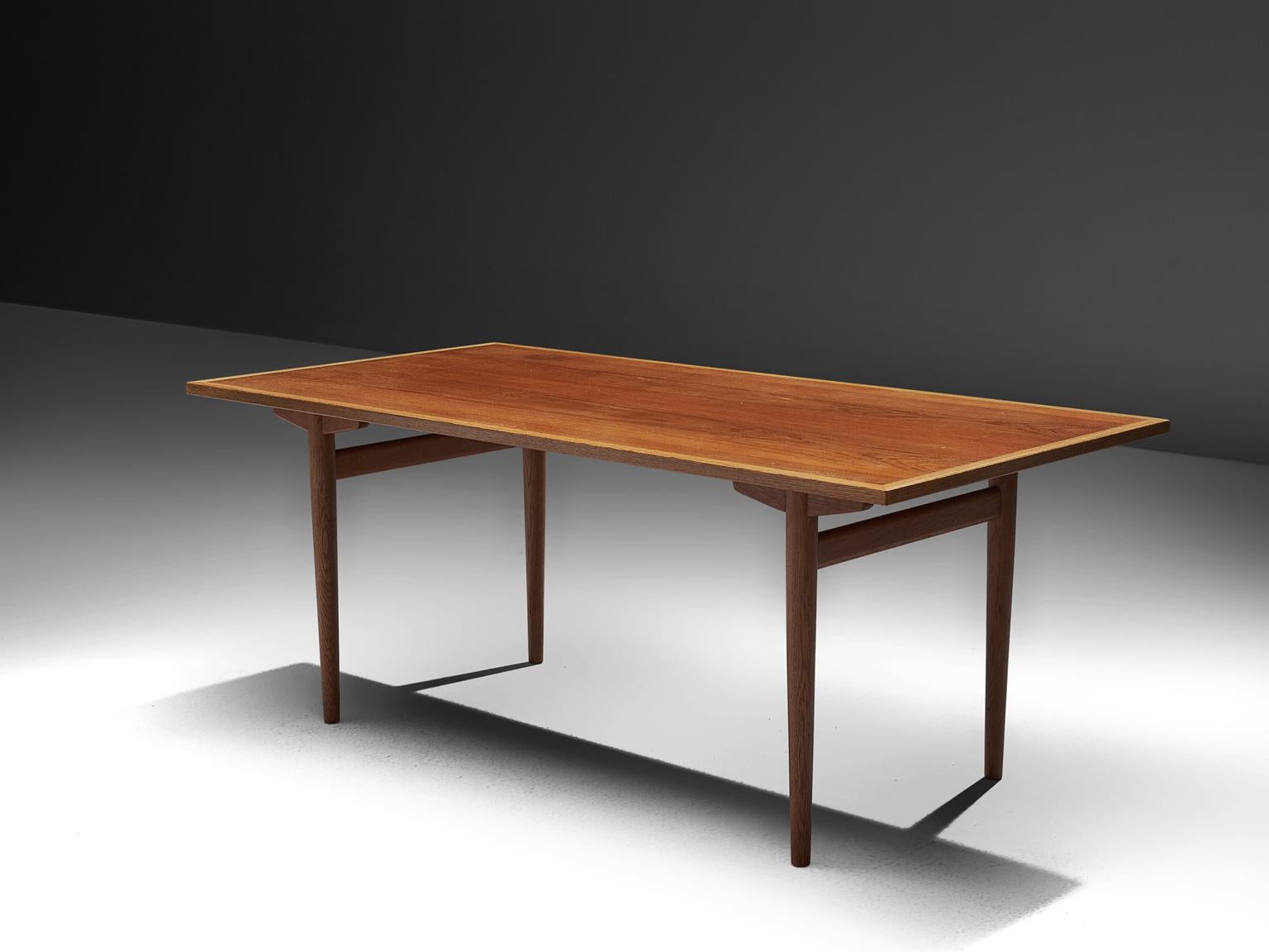 Hans J. Wegner for Andreas Tuck, dining table, teak, oak, Denmark, 1955. 

Dining table with straight tapered legs, by the Danish Designer Hans Wegner. This table is considered as an iconic architectural design by Wegner as he experimented in this