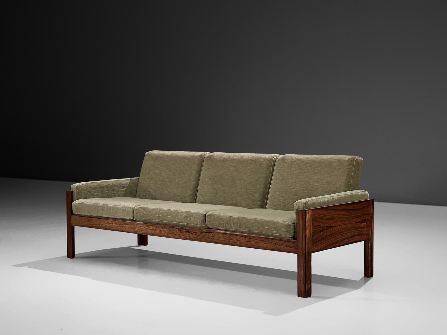 Sofa rosewood and fabric, Scandinavia 1960s.

Three-seat sofa in rosewood. This sofa has a minimalist, modest and modern design. The sofa features an open character due to the generous space underneath and the use of straight elements. The grain