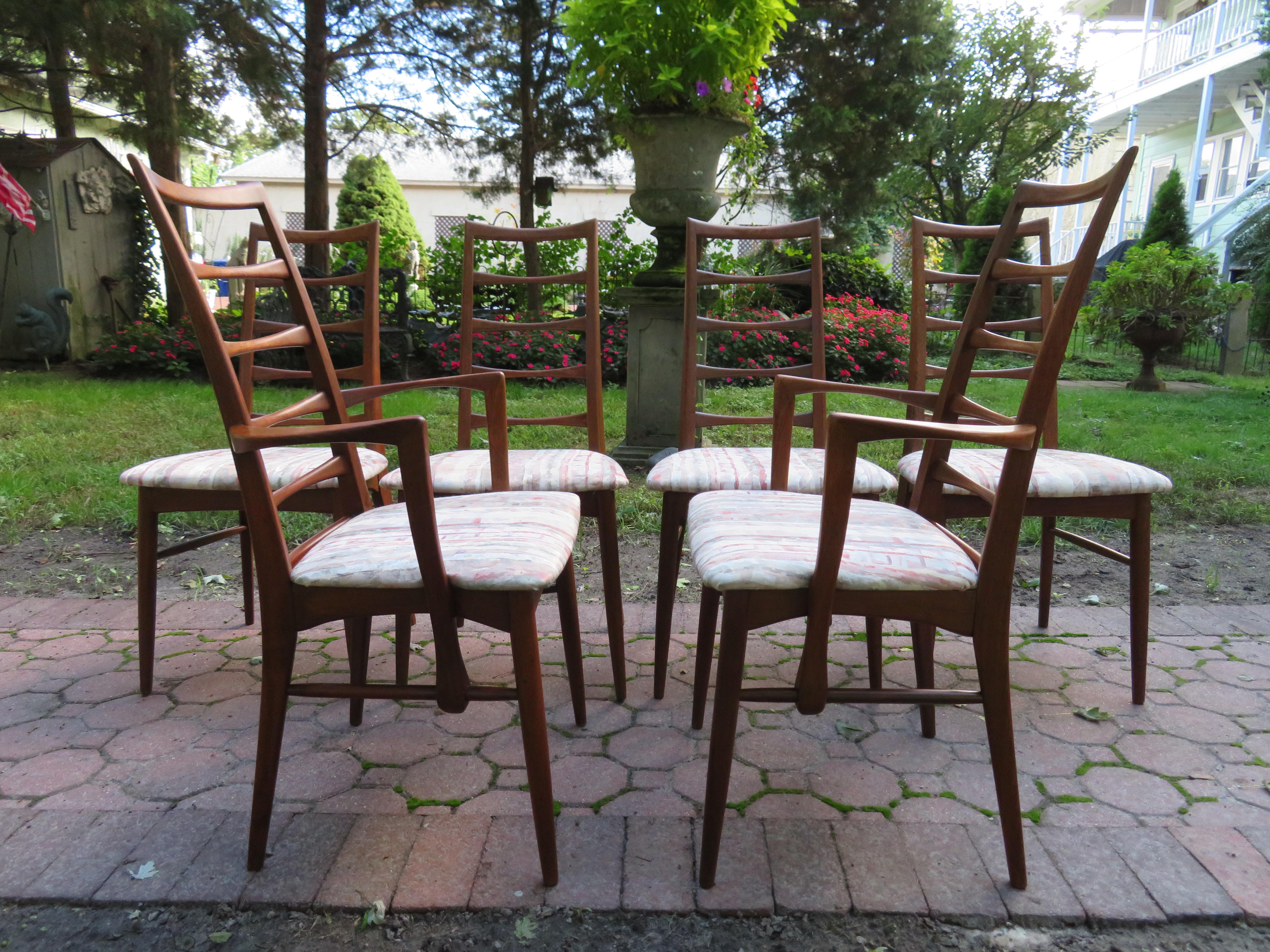 Outstanding set of six signed teak Koefoeds Hornslet ladderback dining chair. The teak has a gorgeous vintage dark patina and is a walnut color. The seat pads look nice but are easily reupholstered for a fresher look. The frames are tight and sturdy