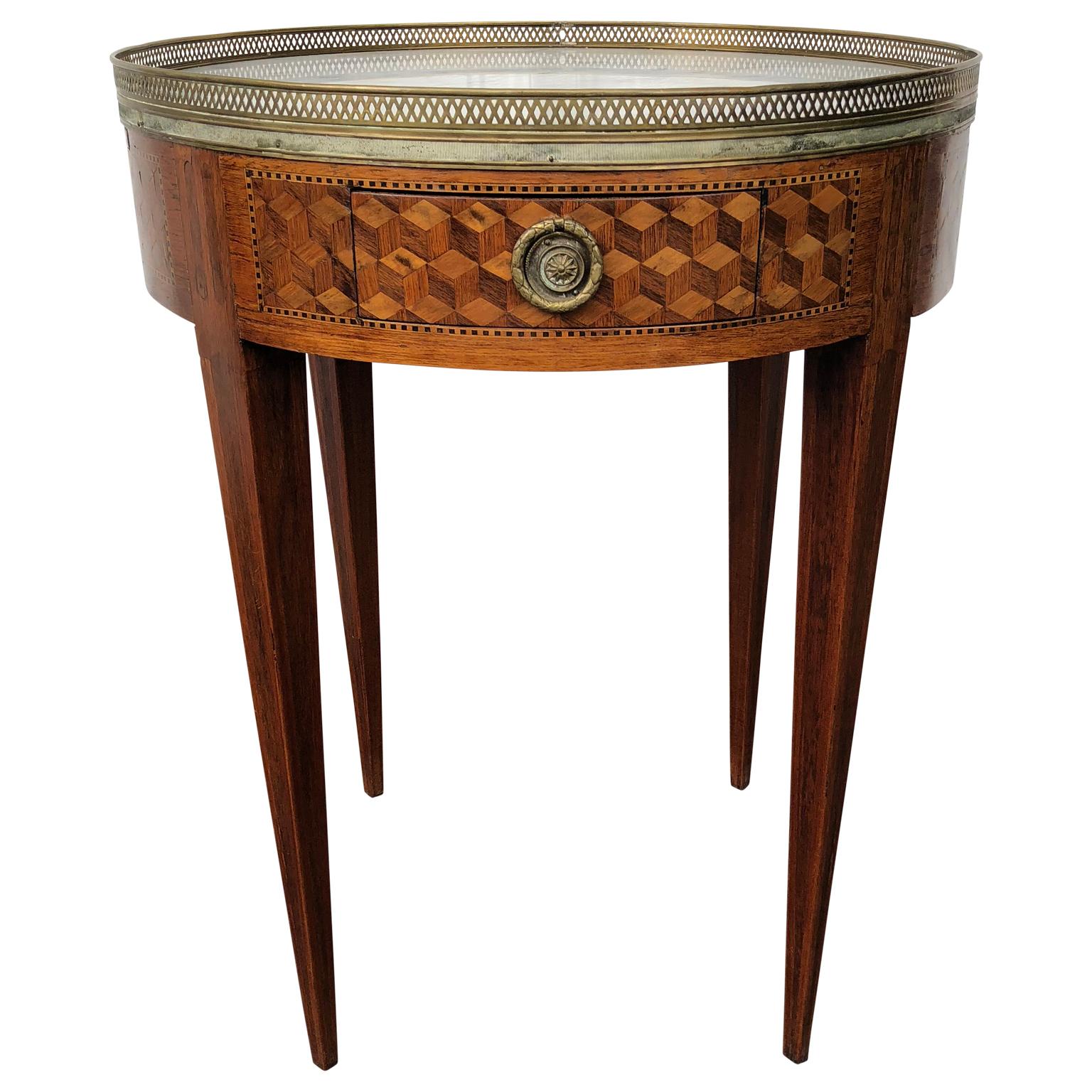 Early 19th century Louis XVI French marquetry bouillotte table.
The amazing classic French marquetry pattern is represented in cubes of satin and lemon wood.