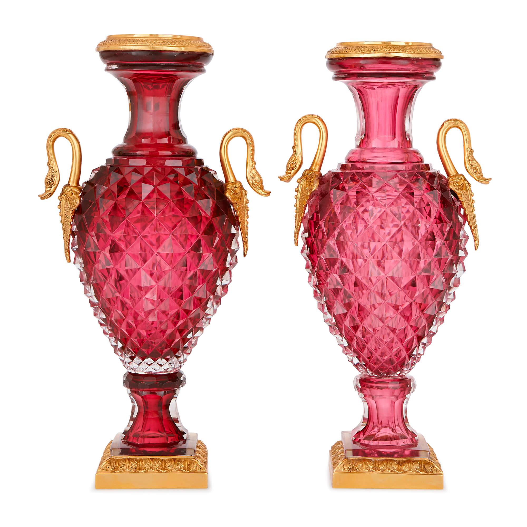 These stunning, jewel-like Russian vases are exceptional examples of the glassmaker's craft. Each one is beautifully built from so-called 'ruby glass', or 'cranberry glass', a distinct type of glass made using large quantities of gold in the