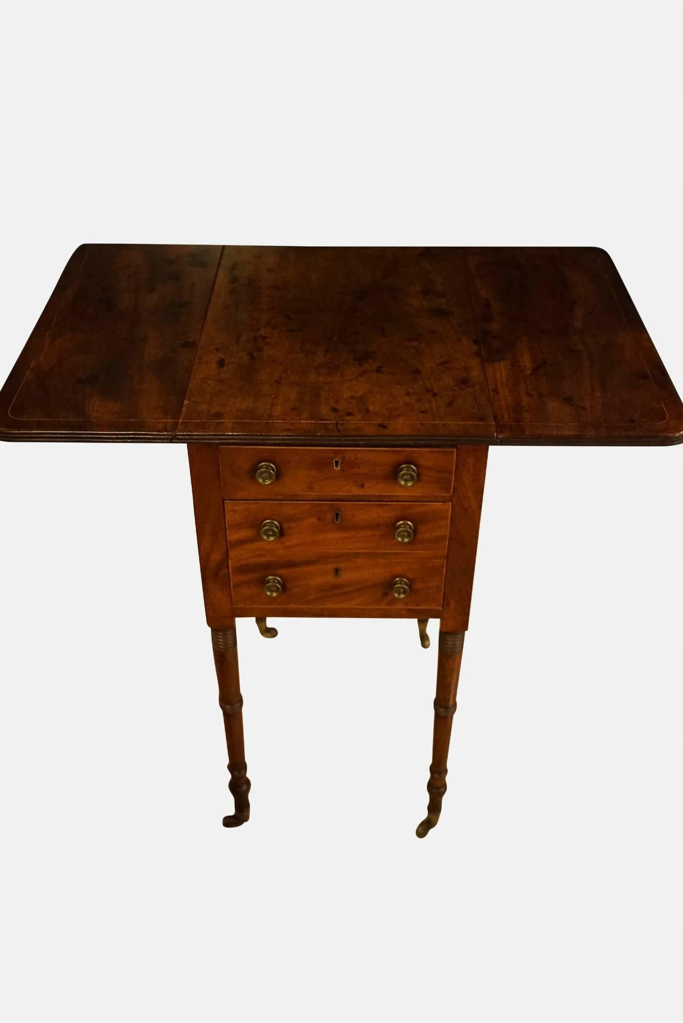 A fine quality Regency mahogany Pembroke work table, with one shallow and one deep drawer, dummied as two, all line inlaid and raised on turned legs to castors,

circa 1815.
 