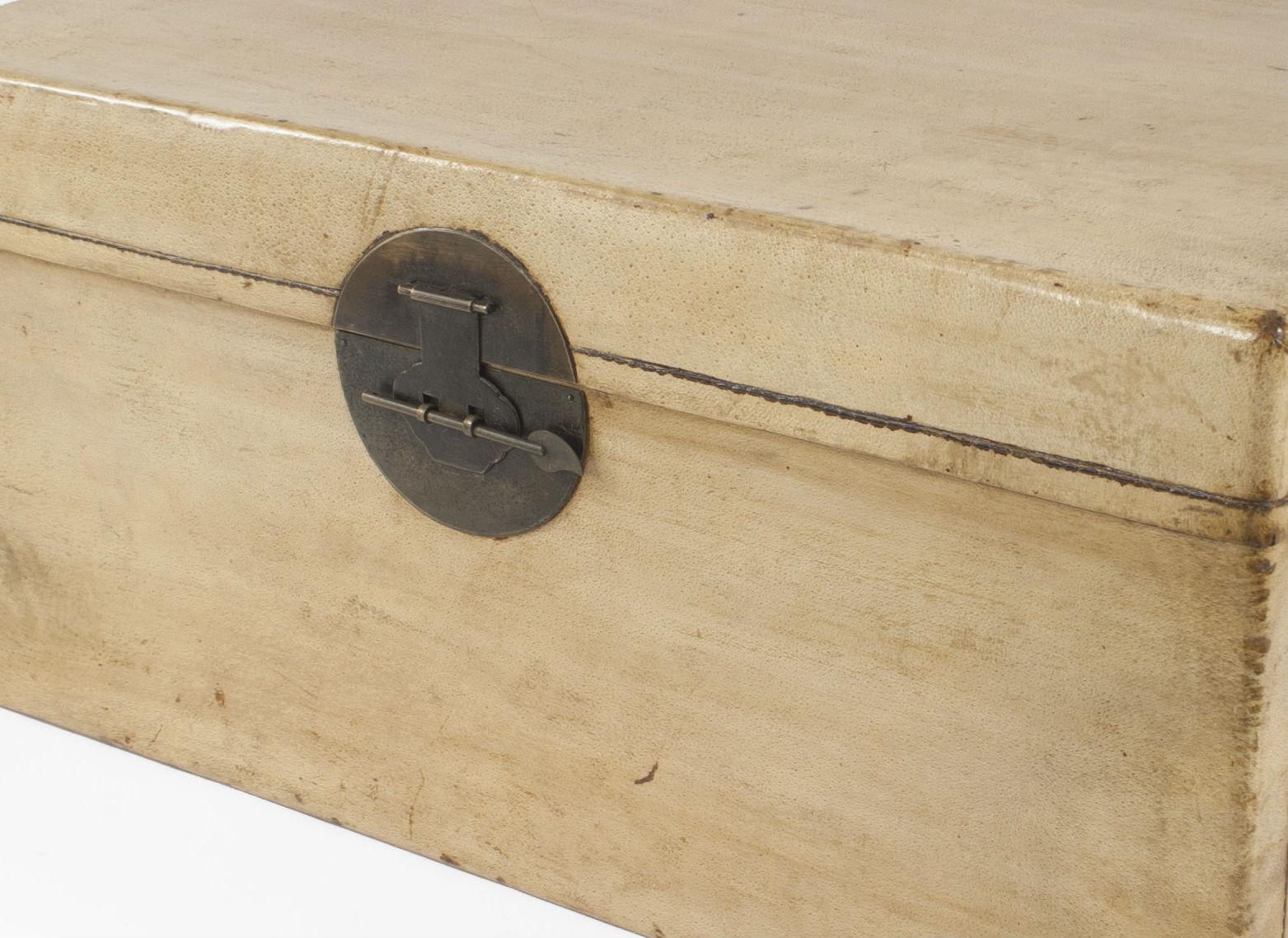 Asian Chinese style midcentury large parchment floor trunk with double side handles and a round brass front plate.
 