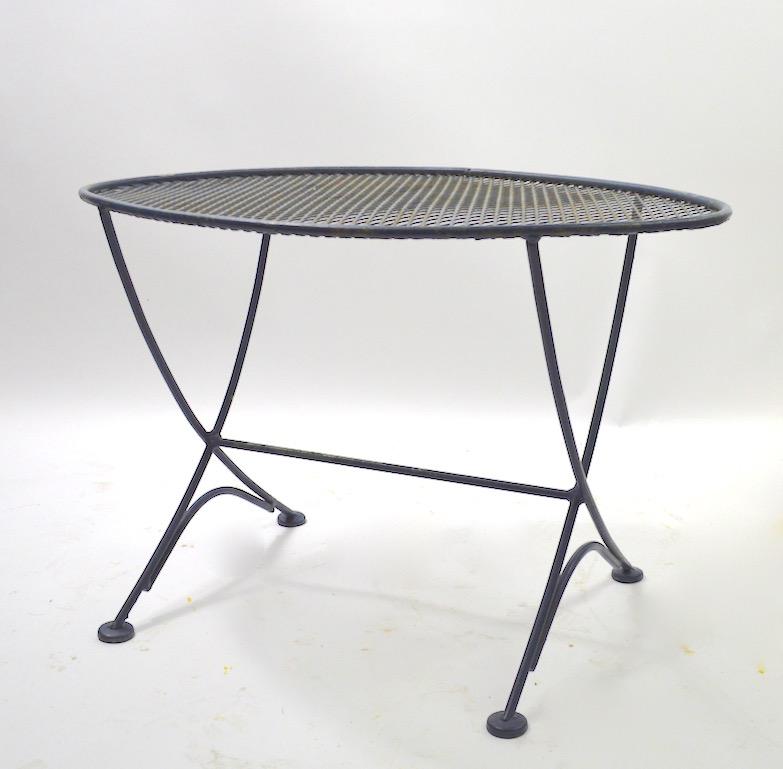 Nice diminutive garden or patio table by Salterini. Hard to find and desirable form, currently in older but not original blue grey paint finish, finish shows wear, normal and consistent with age.