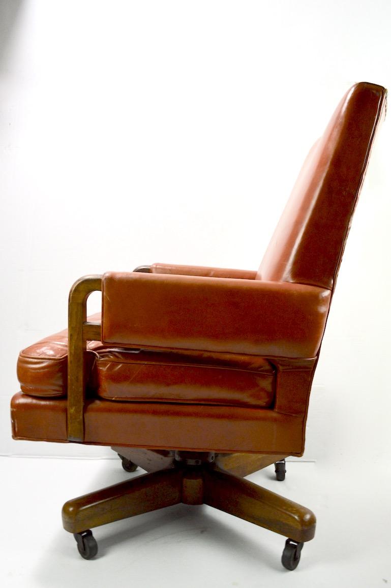 Impressive Art Deco swivel tilt executive high back desk chair. By Stow Davis. This chair is in very nice original condition, with original leather upholstery and solid walnut frame. The chair works smoothly, with all adjustments working. Bold