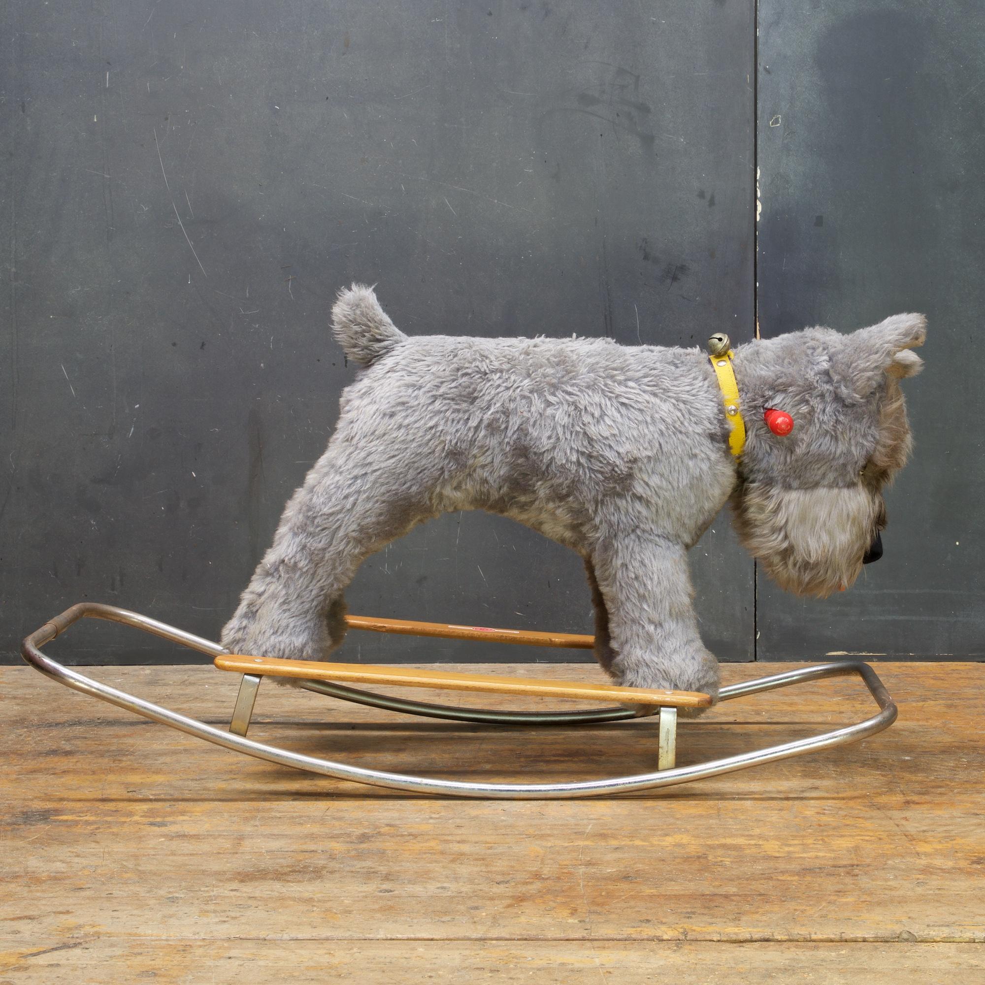 Looks like a character out of the movie, Isle of dogs. A very Interesting vintage infants rocker-riding toy. Stuffed (Kerry Blue) Terrier on birch runners and chromed steel tubular framing. Made in Italy by Trudi.