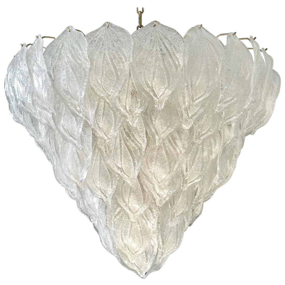 Murano Polar ice chandelier, each with 88 precious handblown glass leaves hanging on the brass frame. Spectacular light effect.
Available also a pair and four pair of sconces.
Provenance from a luxury hotel.
Measures: Height 75 cm, with chain 140