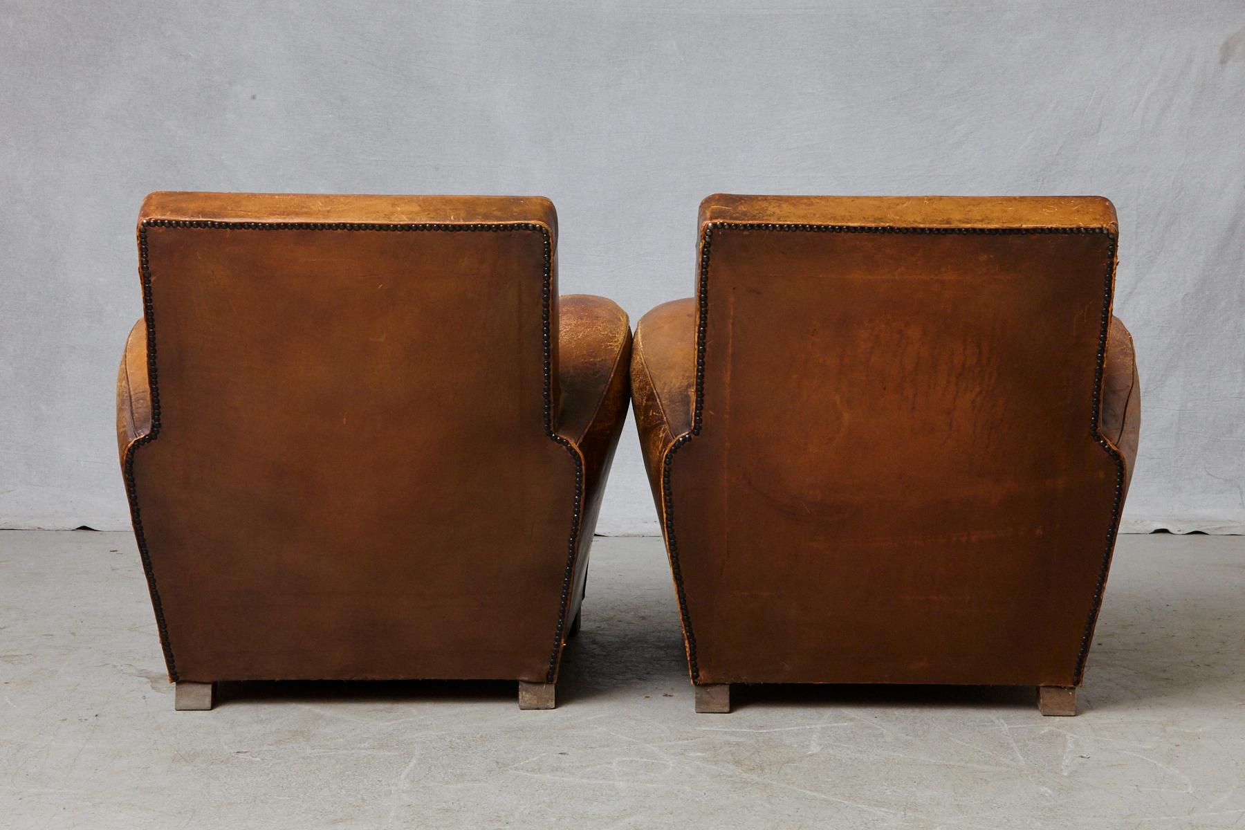 Mid-20th Century Pair of Large Distressed French Leather Fauteuils or Club Chairs, circa 1930s