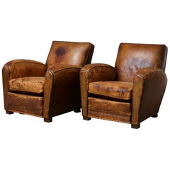Pair of Large Distressed French Leather Fauteuils or Club Chairs, circa 1930s