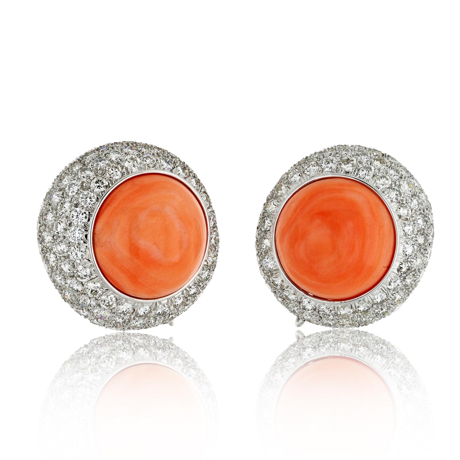 The focal point of each earring is the round button coral, radiating a rich and vibrant hue that adds a touch of natural allure to the ensemble. 

The coral is skillfully surrounded by multiple rows of pave-set round-cut diamonds, creating a