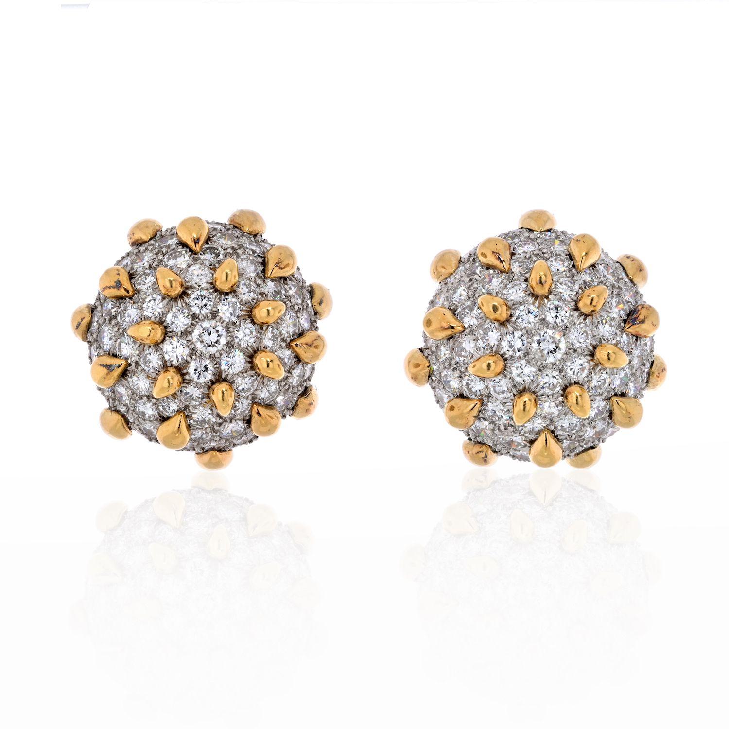 A pair of 18K gold, platinum and diamond bombé ear clips by David Webb, New York.
These dazzling bombé earrings are designed as a dome of pavé-set round brilliant diamonds accented with high polish yellow gold droplets. The gold drops contrast