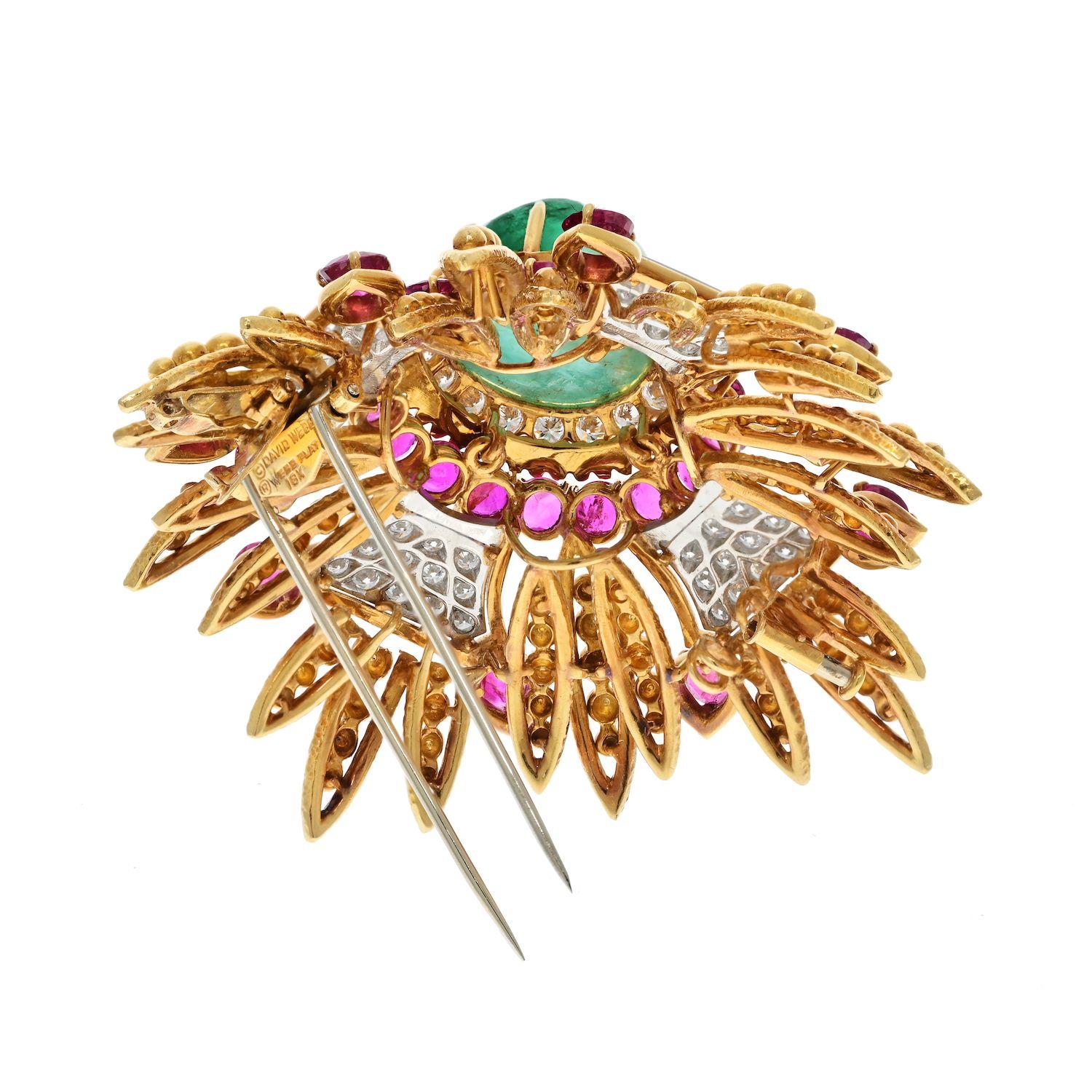 The David Webb Platinum & 18K Yellow Gold 1960's Green Emerald, Rubies, and Diamonds Pendant Brooch is a stunning piece of jewelry that showcases the exceptional craftsmanship and design associated with David Webb. Crafted in a combination of
