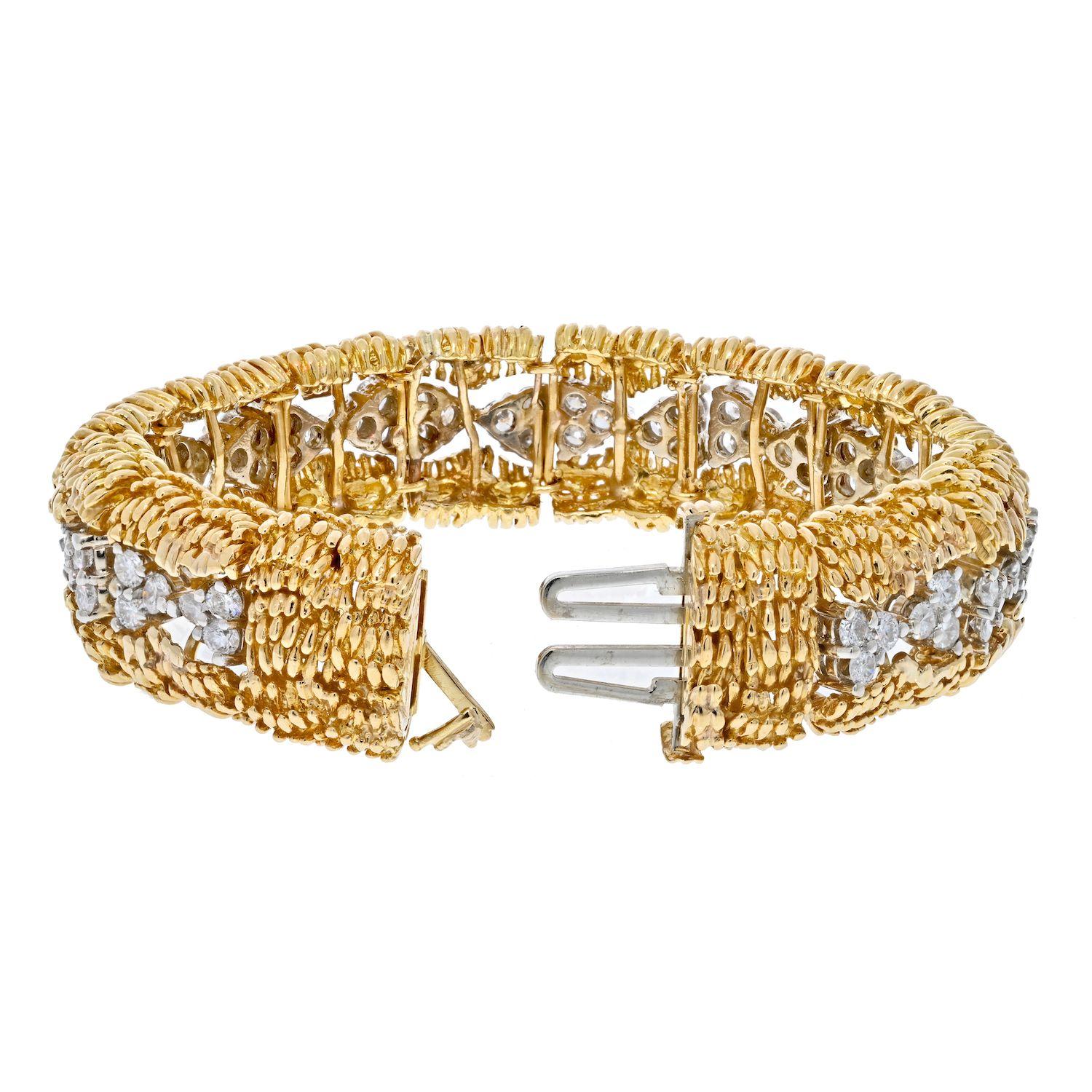 This David Webb bracelet is crafted in 18k yellow gold and platinum . Mounted with round cut diamonds in the center full circle around. 
This bracelet is a true 1960's piece and holds well. 
Box clasp closure with safety. 
It is 16mm wide and will