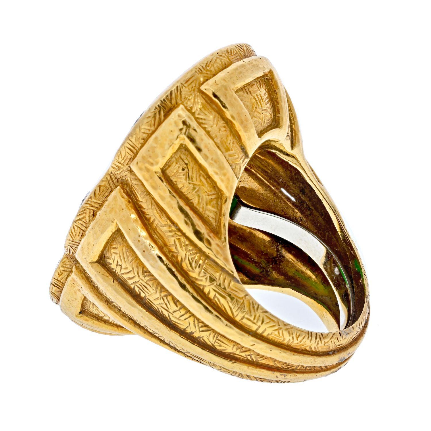 Large statement ring perfect for cocktails and fashion outings. Made by American designer David Webb, centering a carved green jade plaque featuring a stylized dragon, the hammered gold mounting accented with round diamonds.
Diamonds approx.