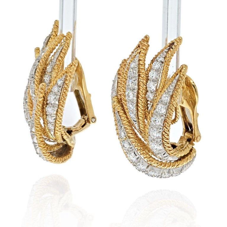 David Webb 18k yellow gold leaf motif earrings crafted in 18k yellow gold and platinum. 
Lovely foliage design that is a staple for many jewelry houses. 
Diamond shape: Round
Diamond Weight: 3.00
Color/Clarity: G-VS2
Length x Width: 33 x 19mm