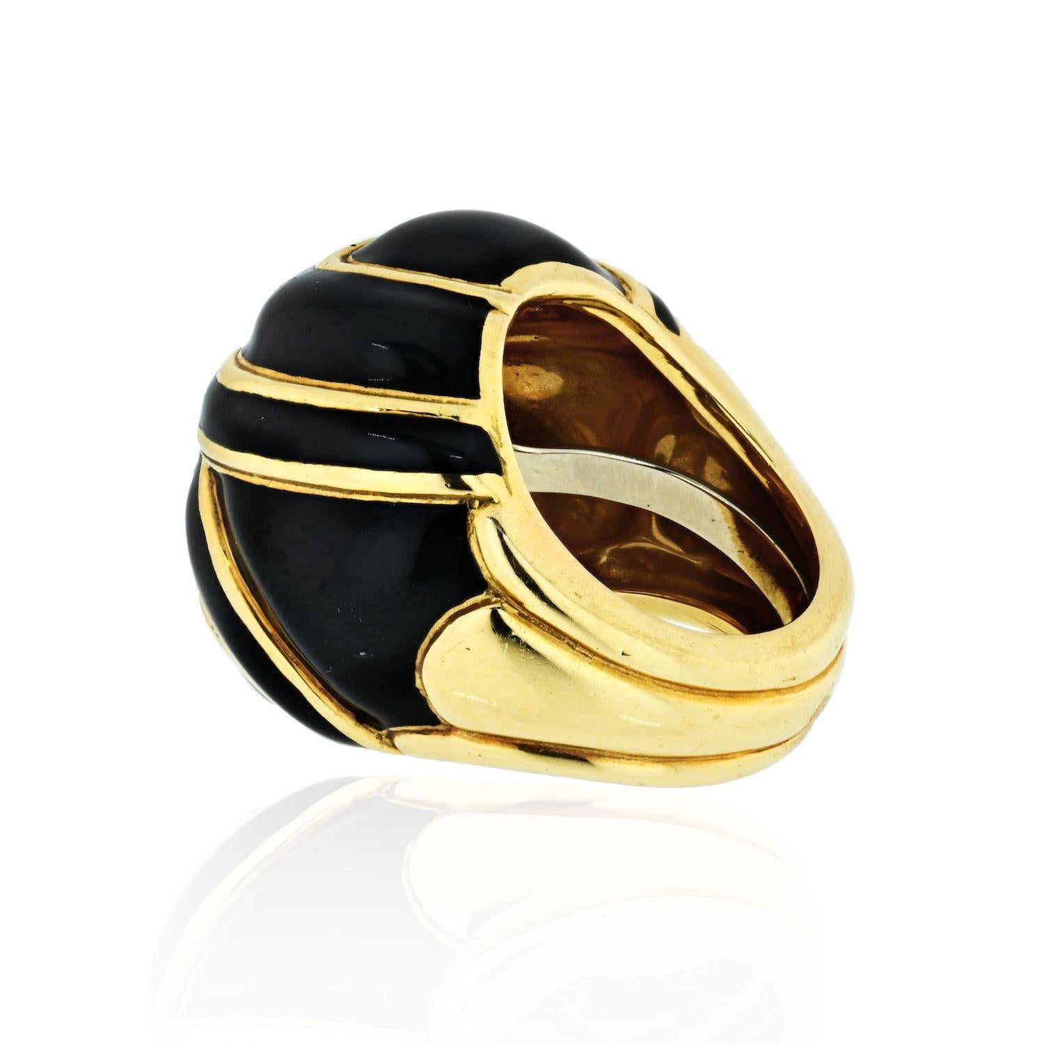 18 kt., the spiral bombe ring composed of overlapping ribbons applied with black enamel and outlined by polished gold wire, signed Webb. Size 5.
