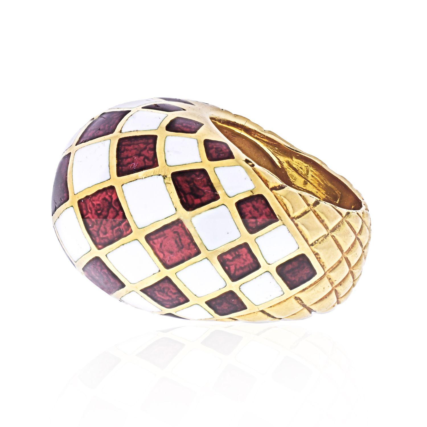 The large domed top with dark red and white enamel checkerboard design, to a tapering textured gold band in 18k. Signed David Webb.
As with every David Webb ring the sizing horse shoe bar that is made of platinum, located inside the ring allows this